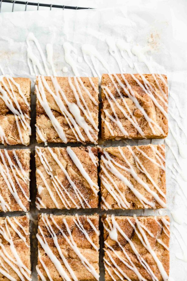 overhead shot of cinnamon roll blondies drizzled with cream cheese glaze