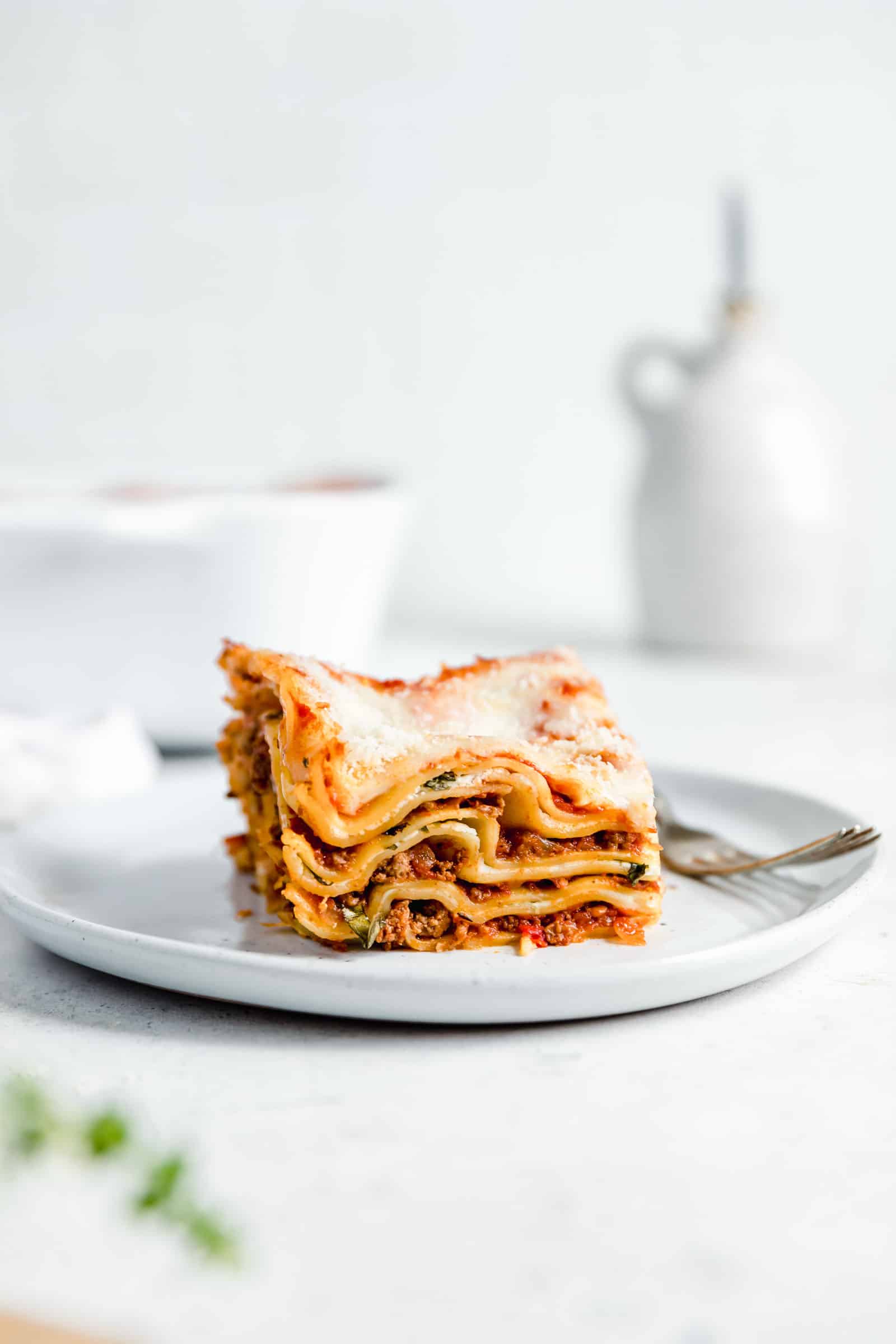 one serving of classic lasagna with cheesy top on speckled plate
