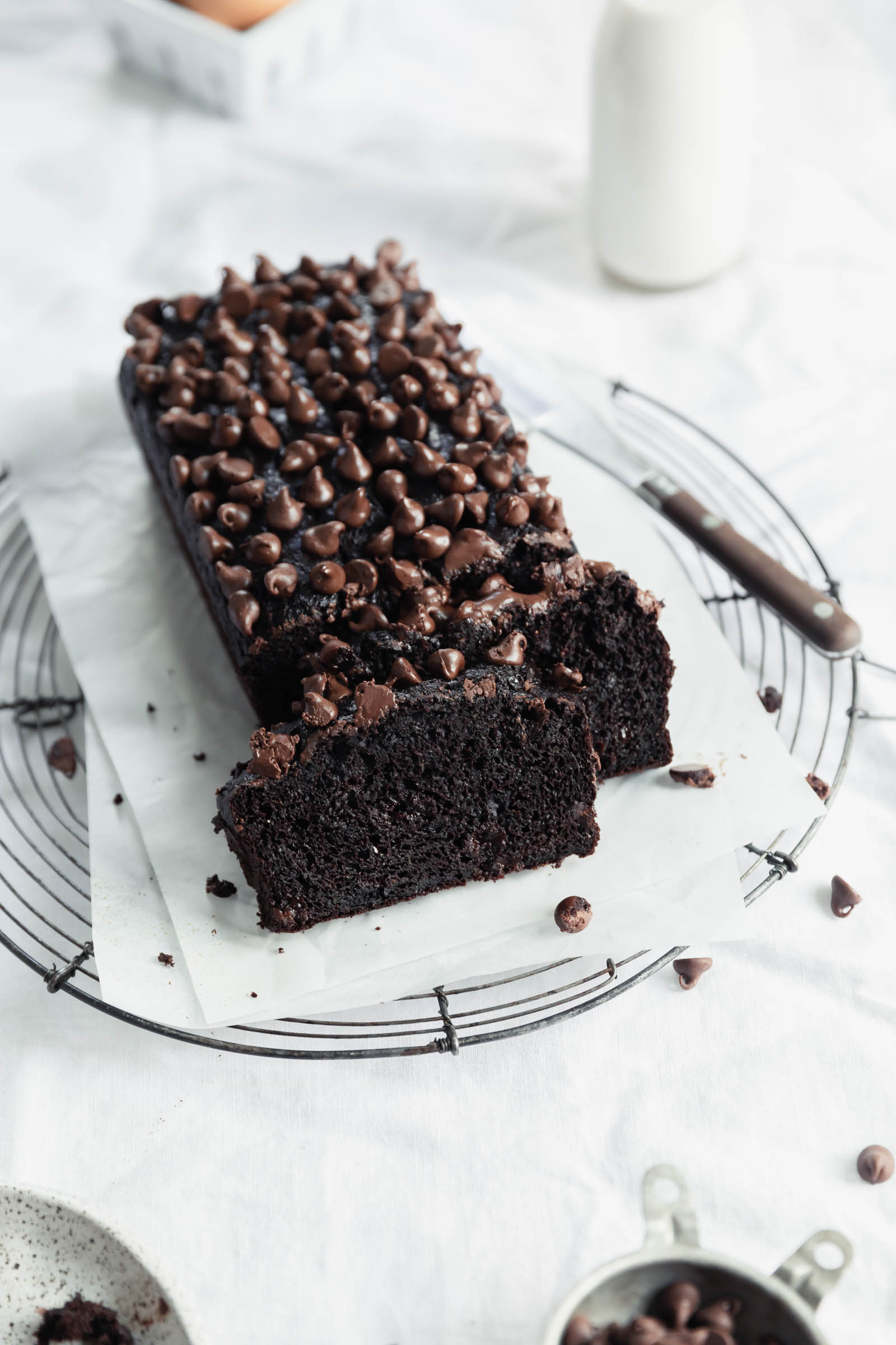 chocolate zucchini bread on an angle with a slice cut out and a knife