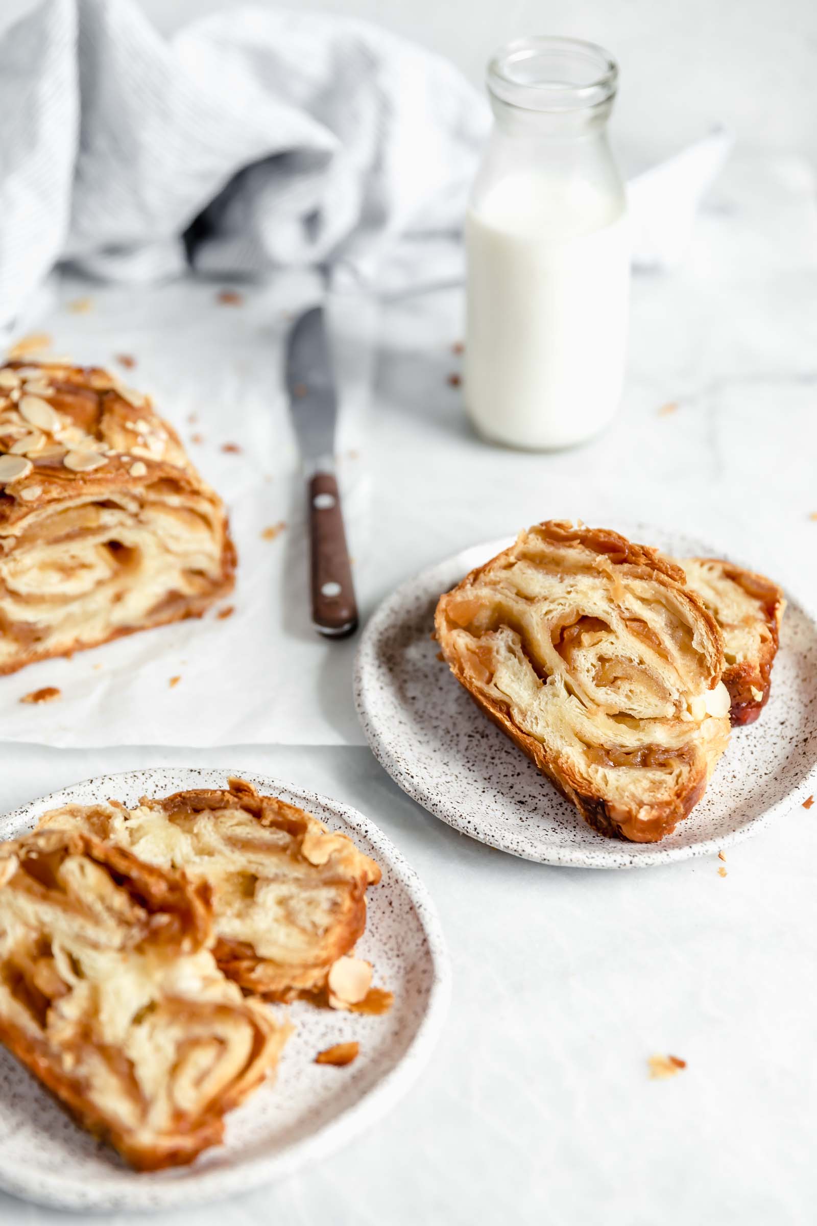 two slices of apple baba on plates