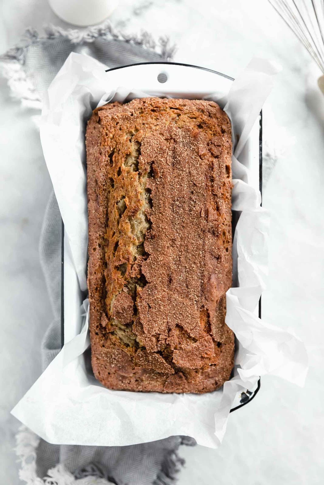 overhead shot of full snickerdoodle banana bread in pan