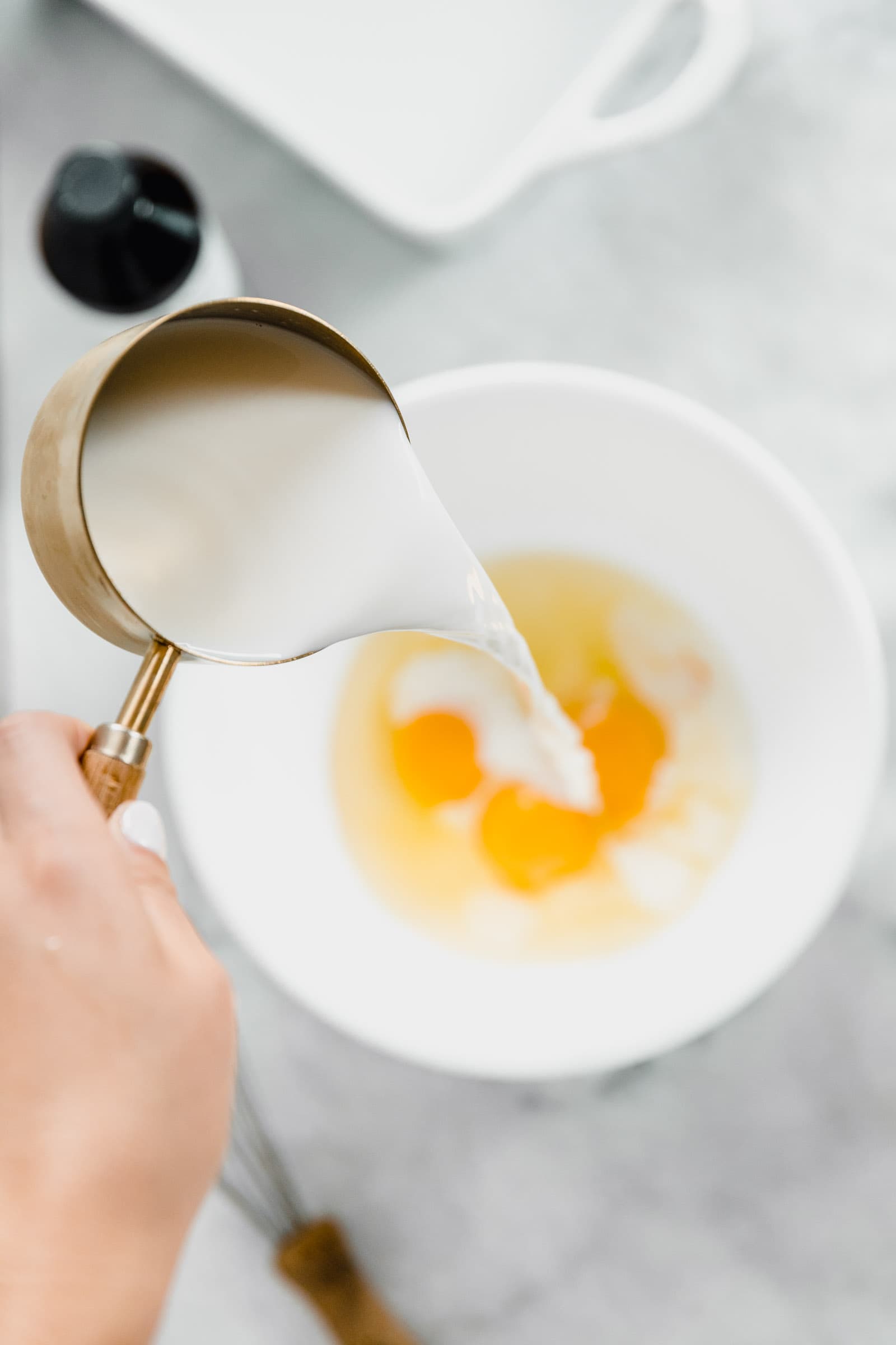 milk pouring into bowl from overhead