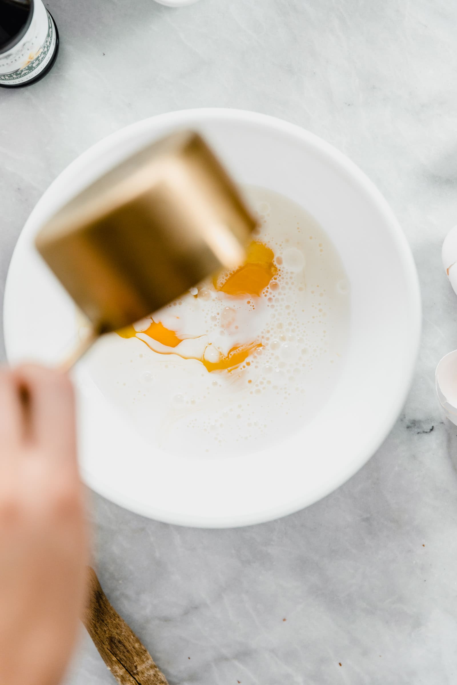 overhead shot of sugar falling into bowl