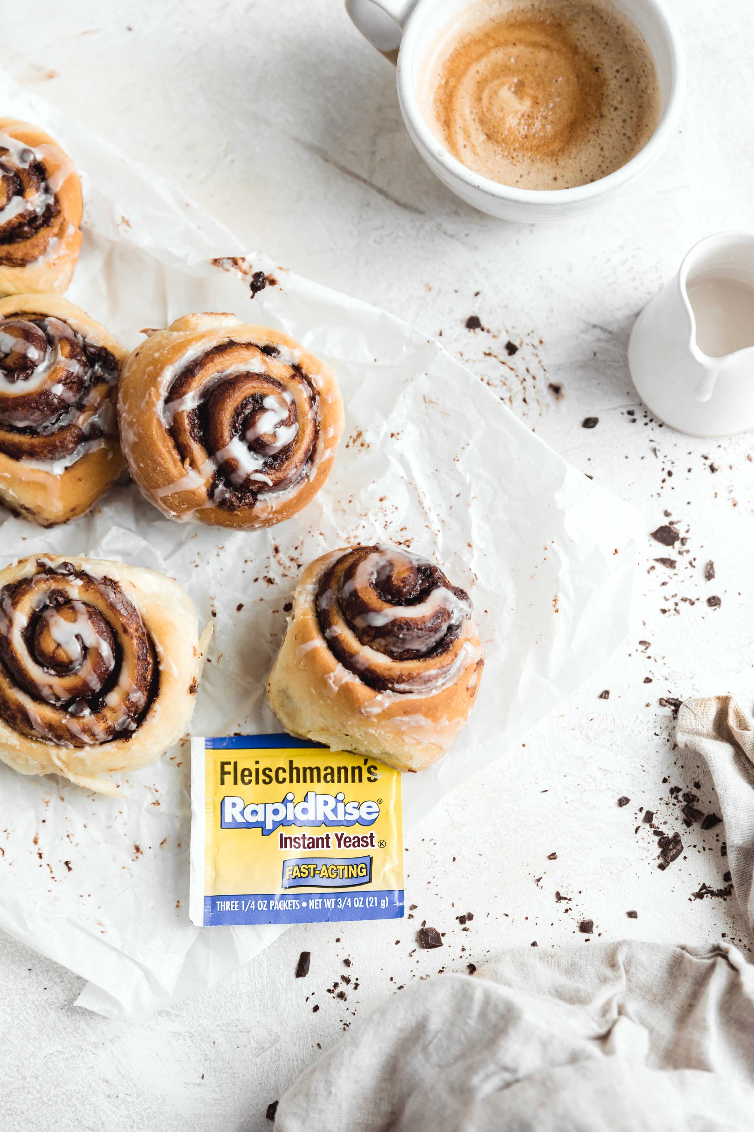 decadent 1 hour chocolate cinnamon rolls in a pan with the gooiest center and a cream cheese icing drizzle
