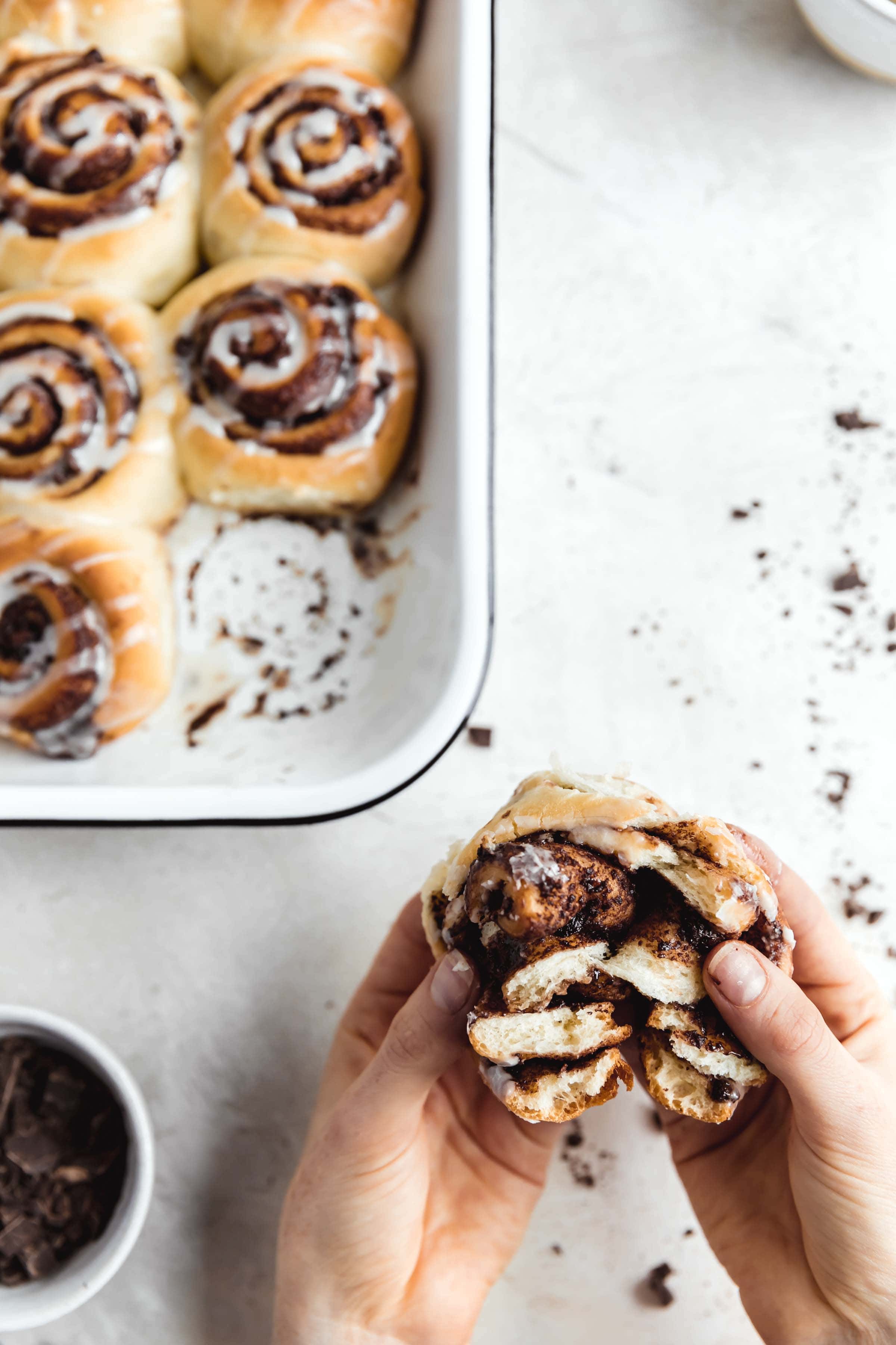 decadent 1 hour chocolate cinnamon rolls in a pan with the gooiest center and a cream cheese icing drizzle