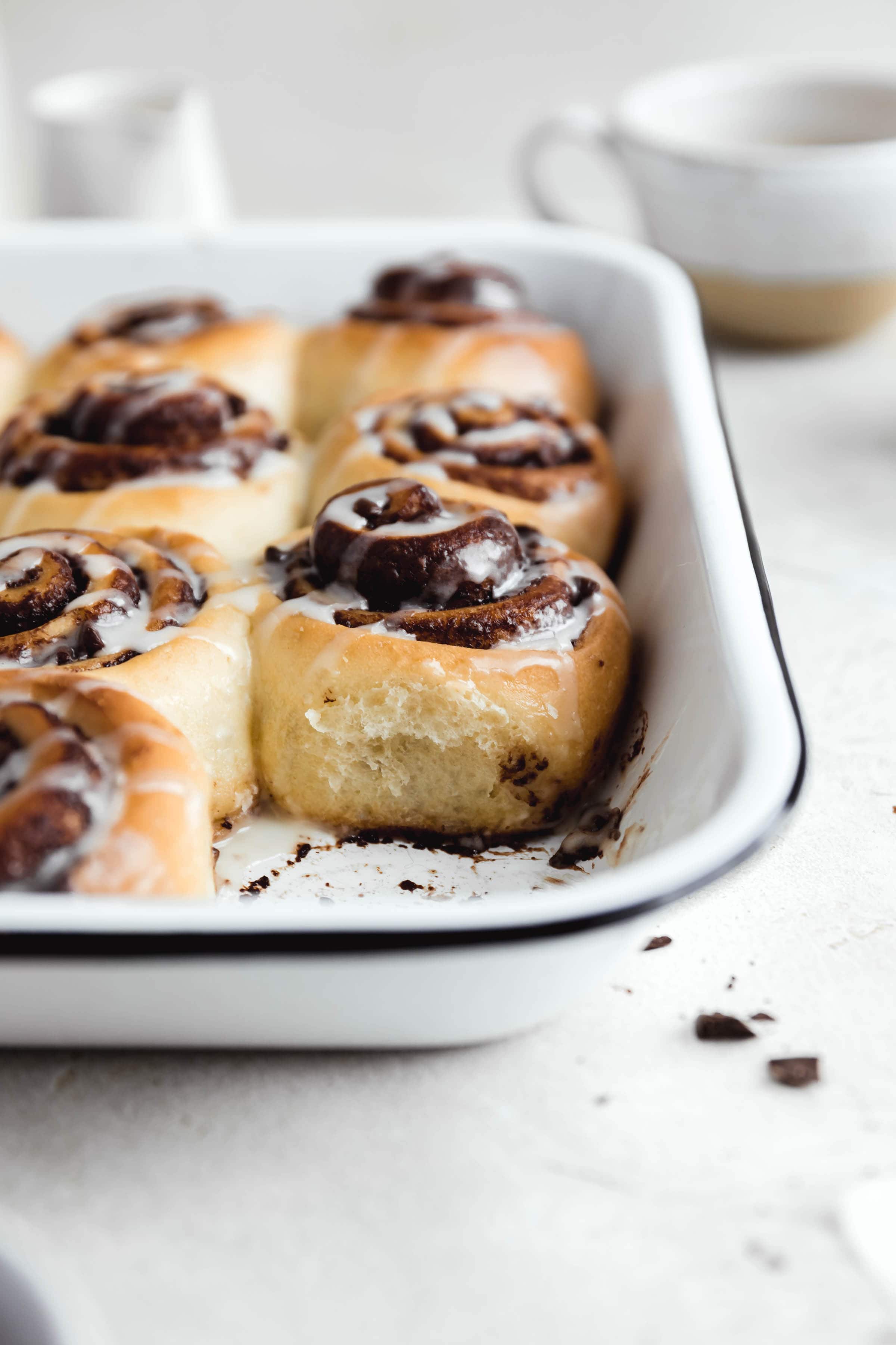 scrumptious pan of chocolate cinnamon rolls with one taken out