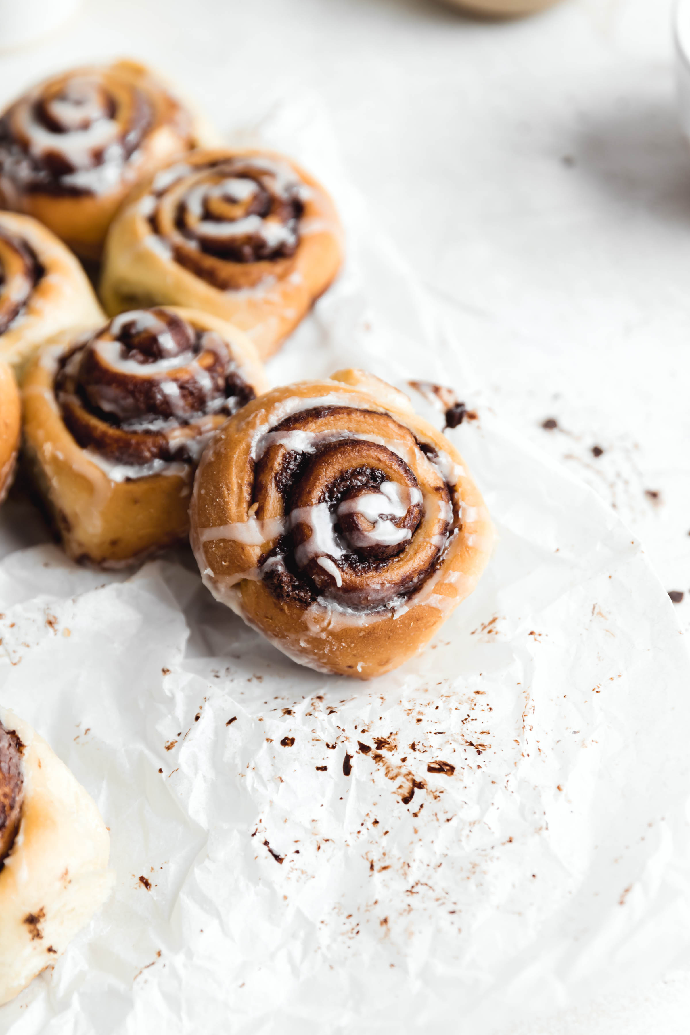 chocolate cinnamon rolls drizzled with cream cheese icing