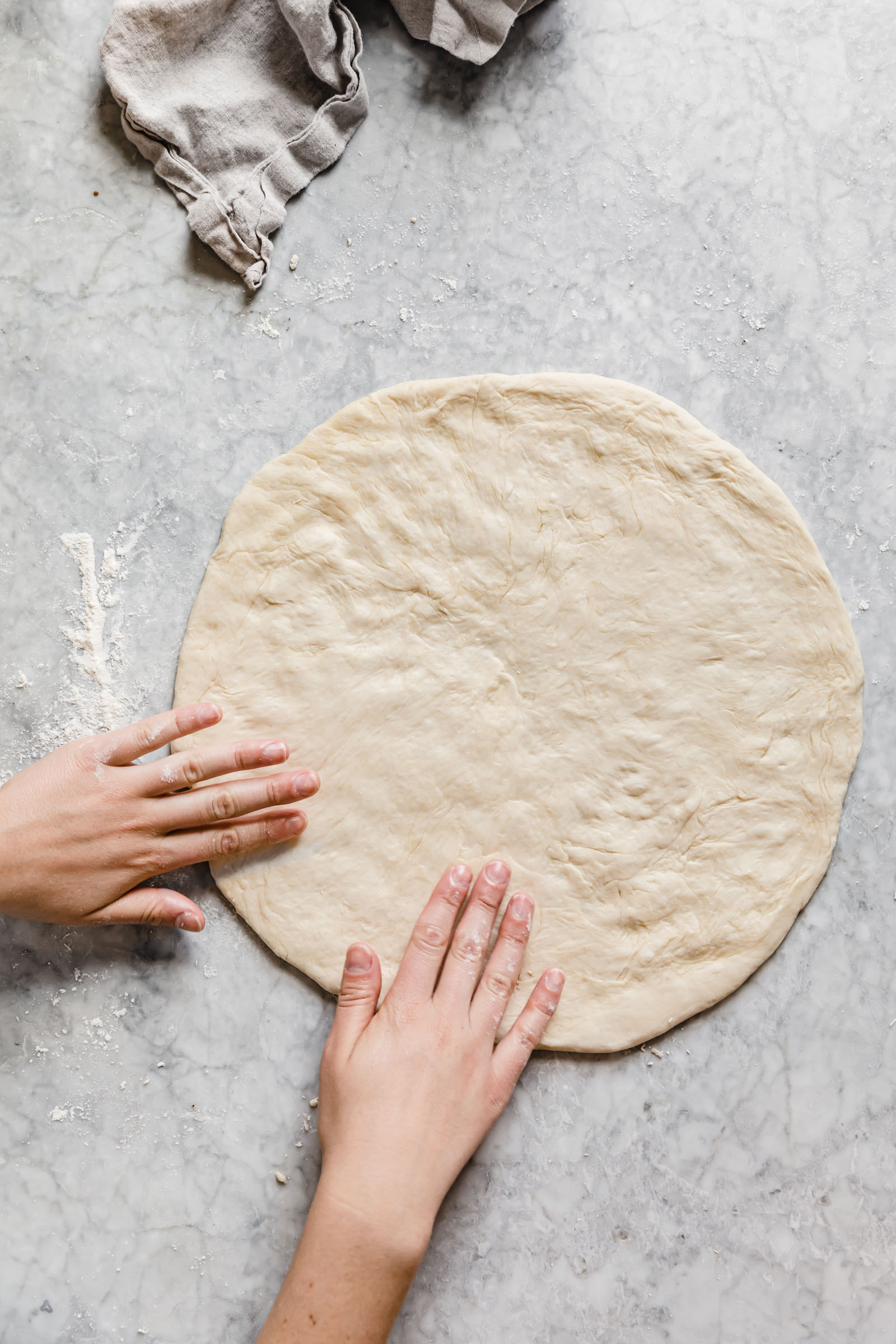 stretch out pizza dough to a 12 inch round