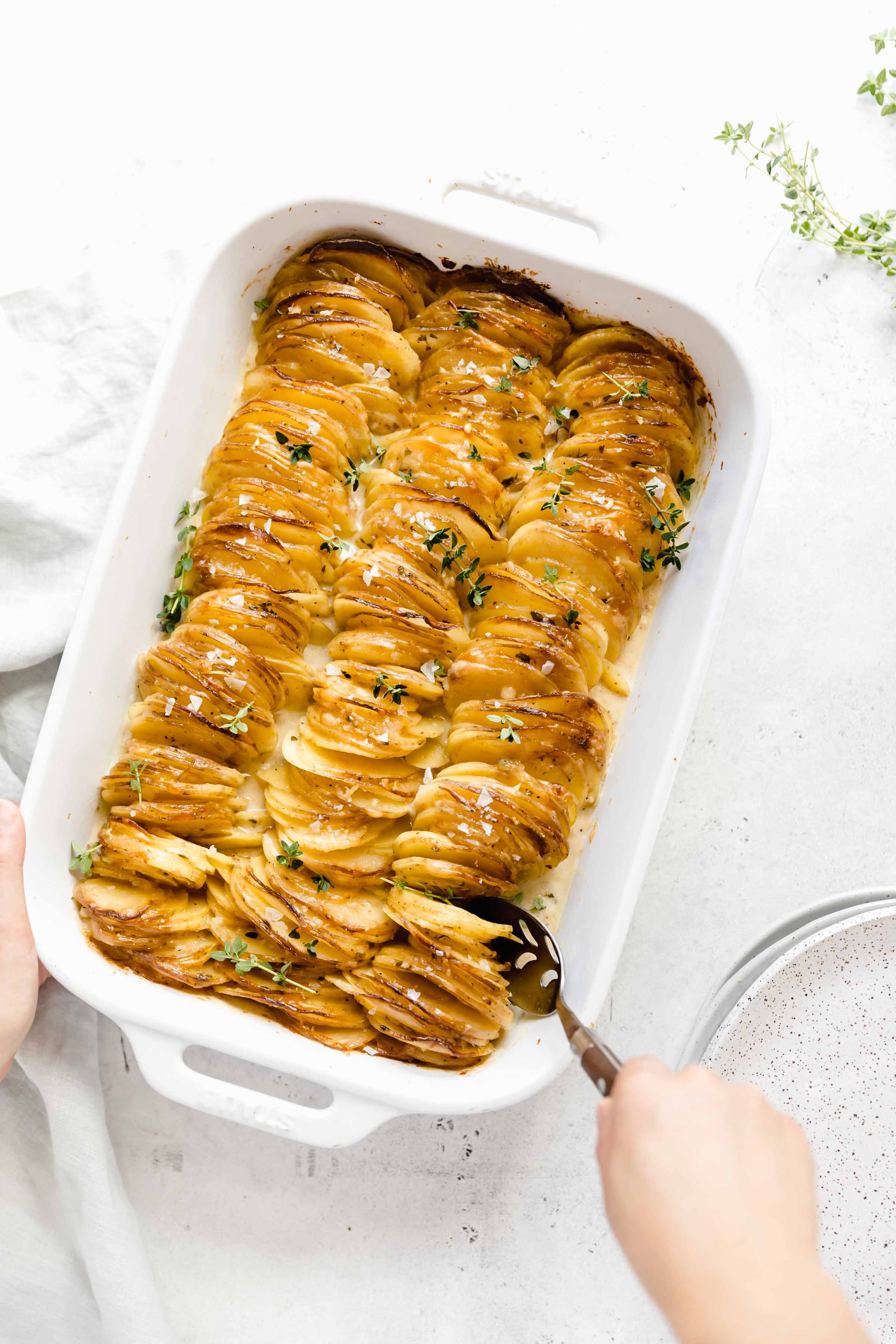 Cheesy Scalloped Potatoes stacked vertically to create a crispy, gooey, cheesy side dish the whole family will love!