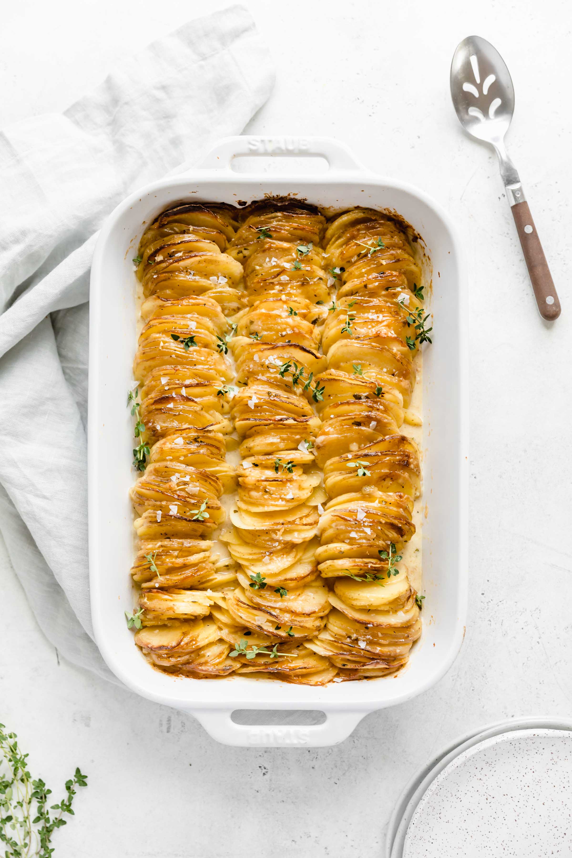 Cheesy Scalloped Potatoes stacked vertically to create a crispy, gooey, cheesy side dish the whole family will love!