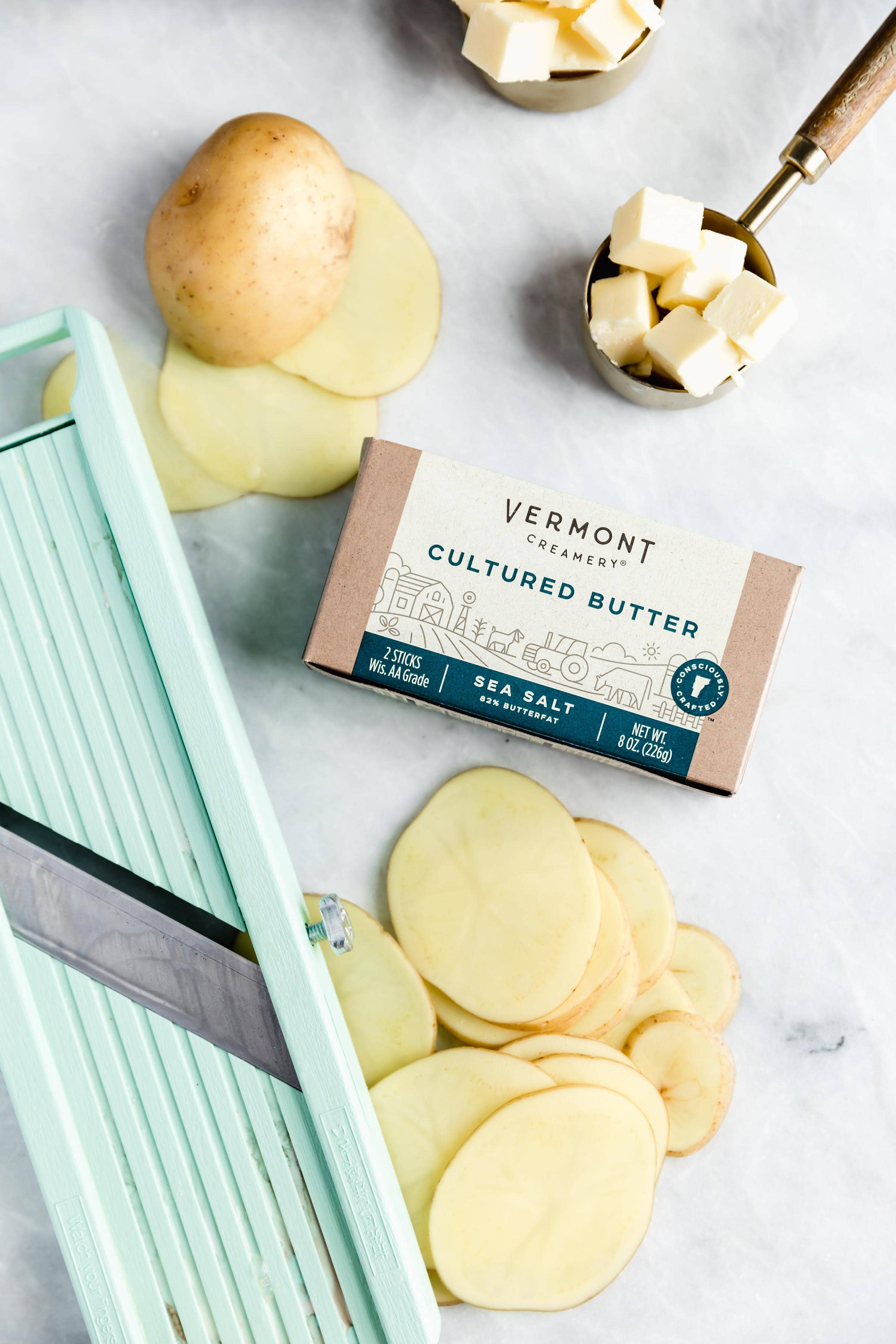 Cheesy Scalloped Potatoes stacked vertically to create a crispy, gooey, cheesy side dish the whole family will love!