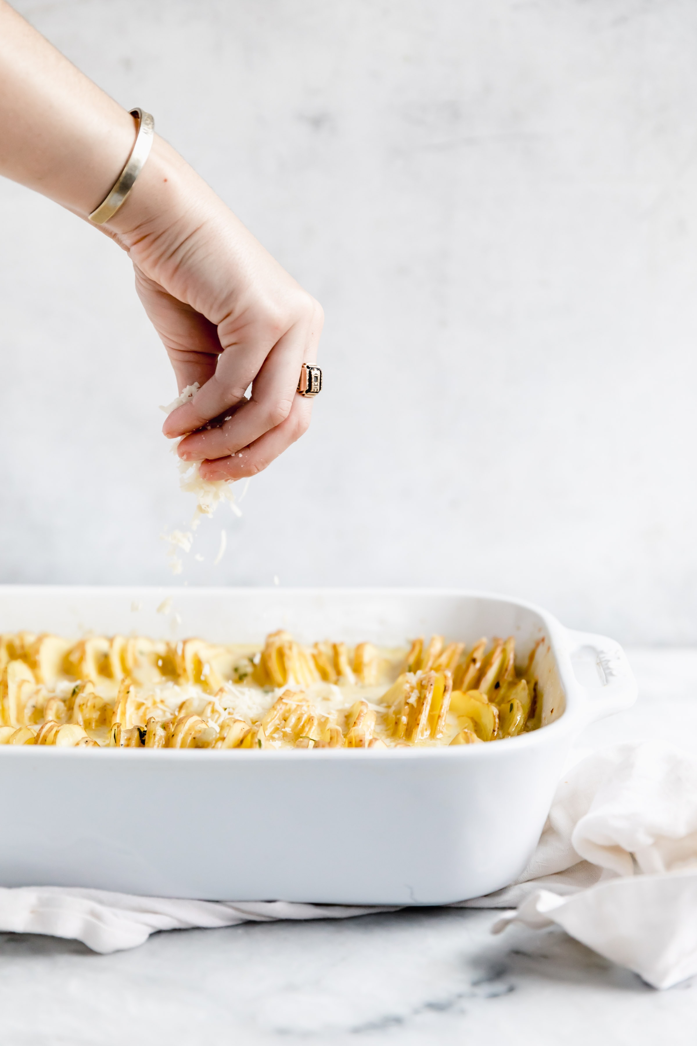 sprinkle cheese onto potatoes