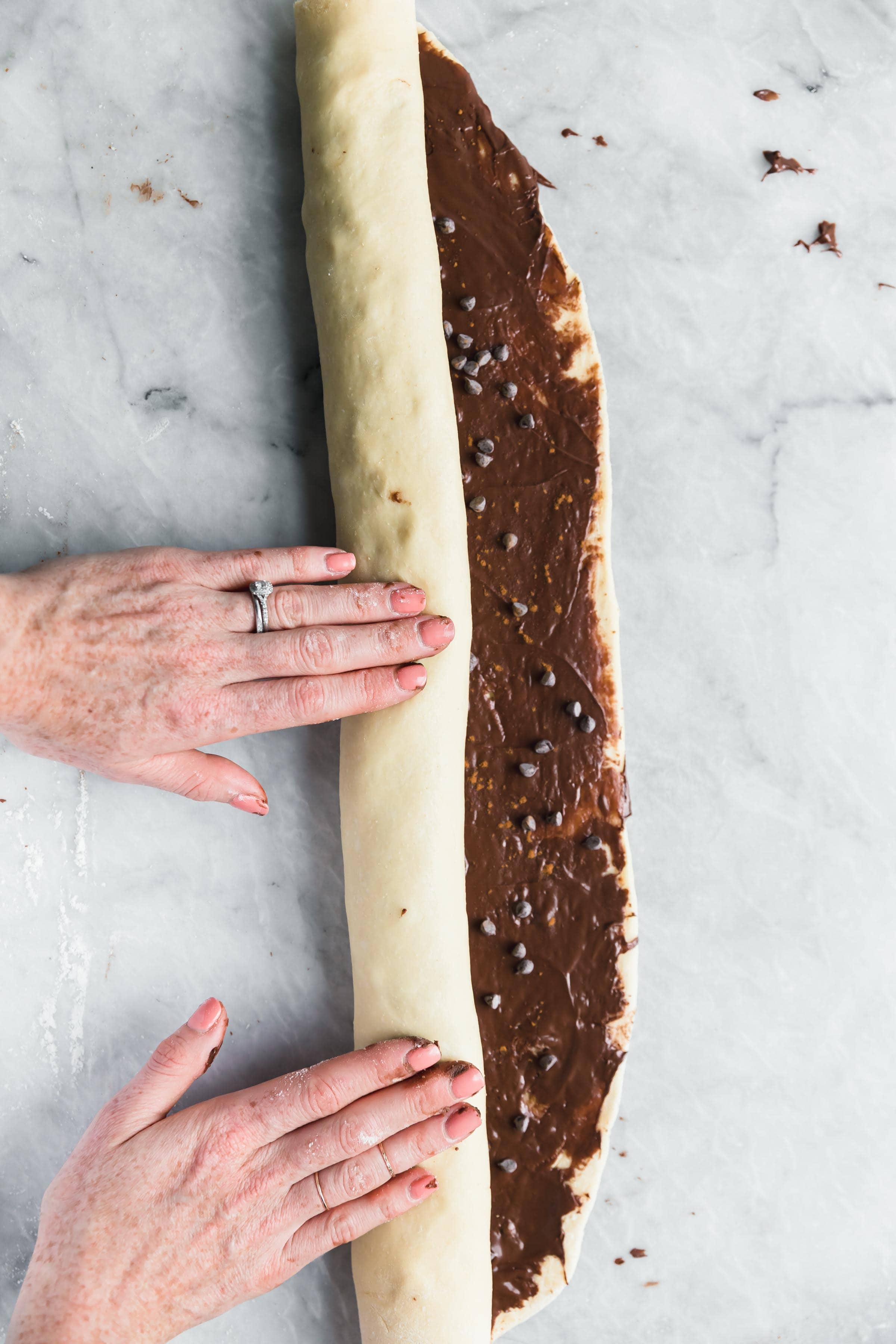 roll the cinnamon roll dough into a tight log