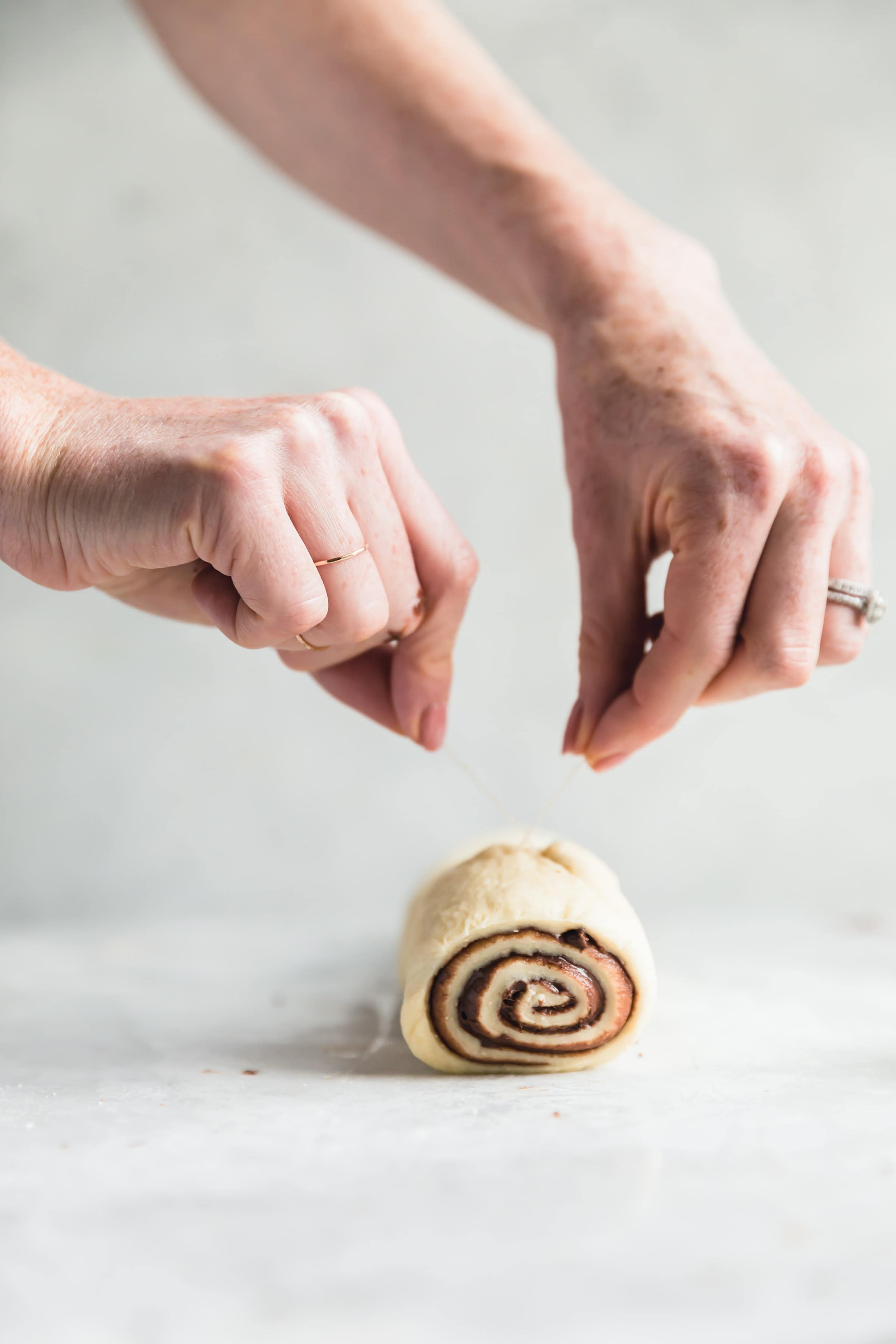 cinnamon roll dough cut with floss