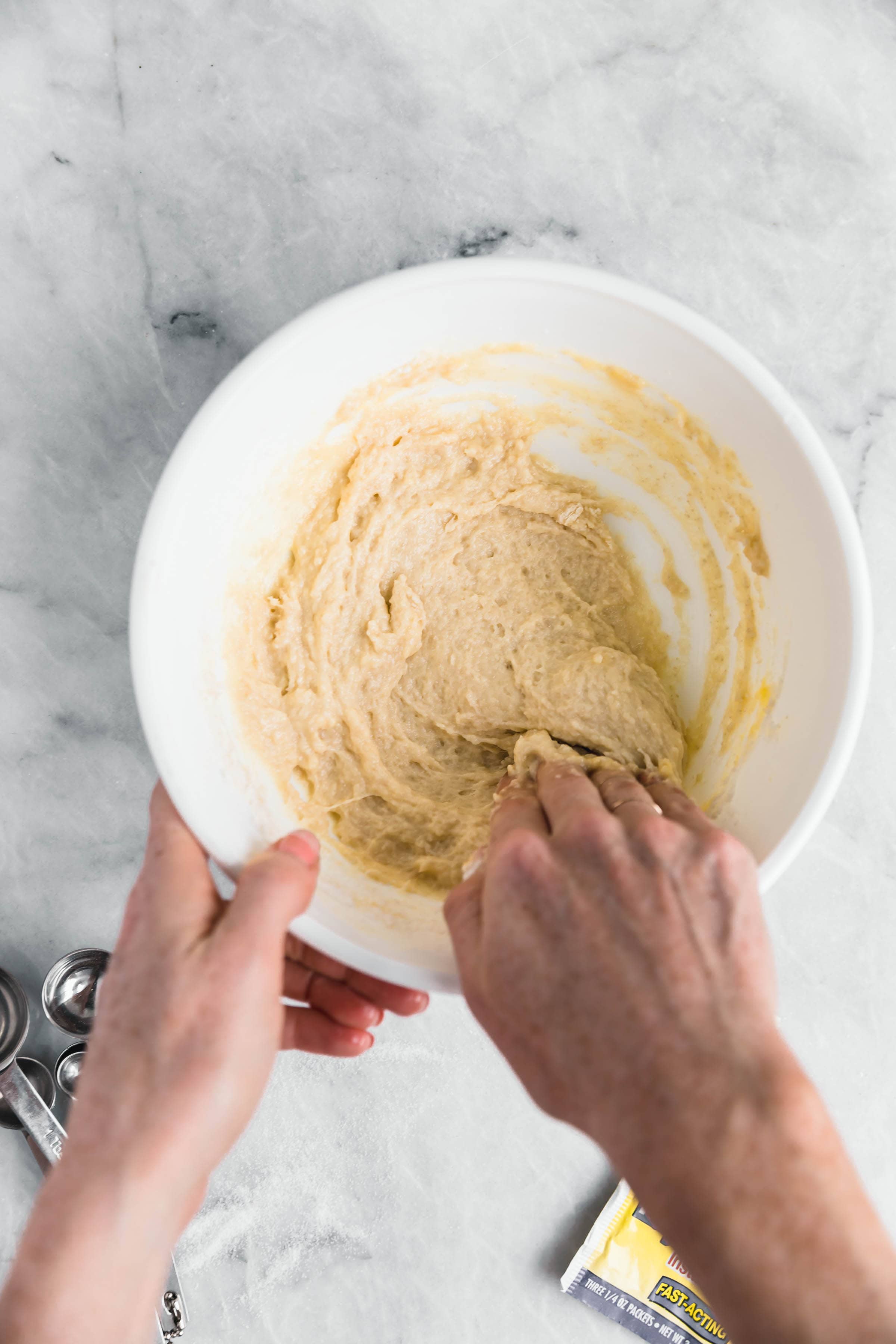 cinnamon roll dough stirred together using hands