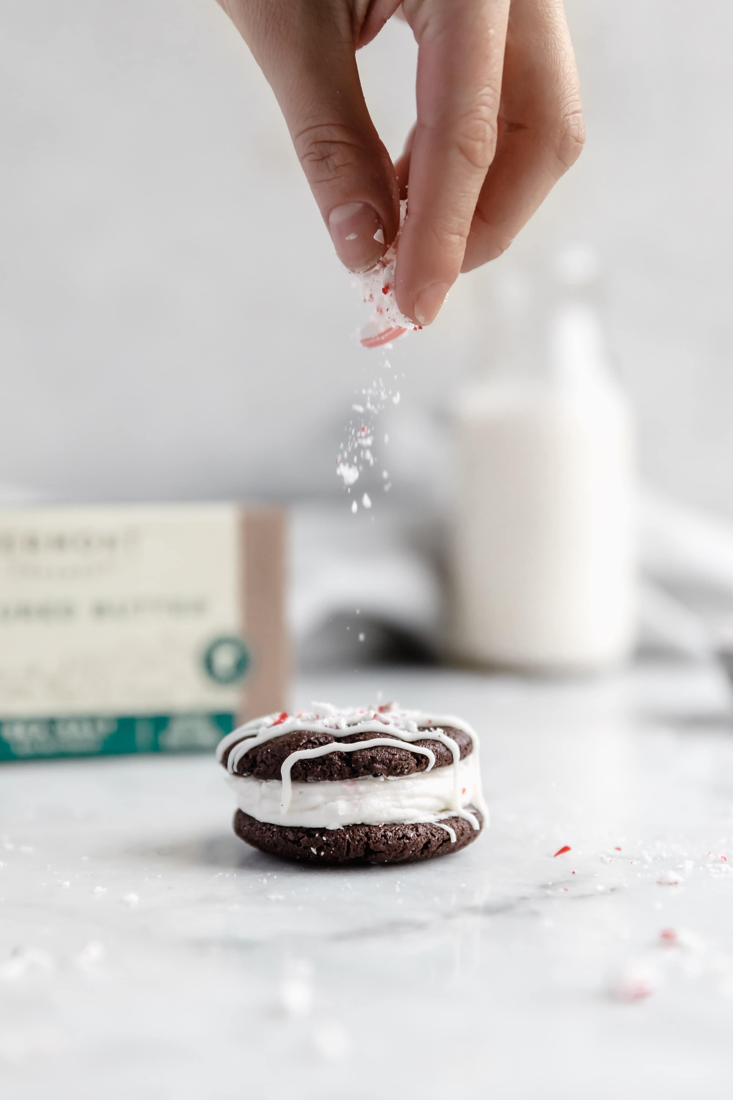 crushed up peppermint candy sprinkled on sandwich cookie 