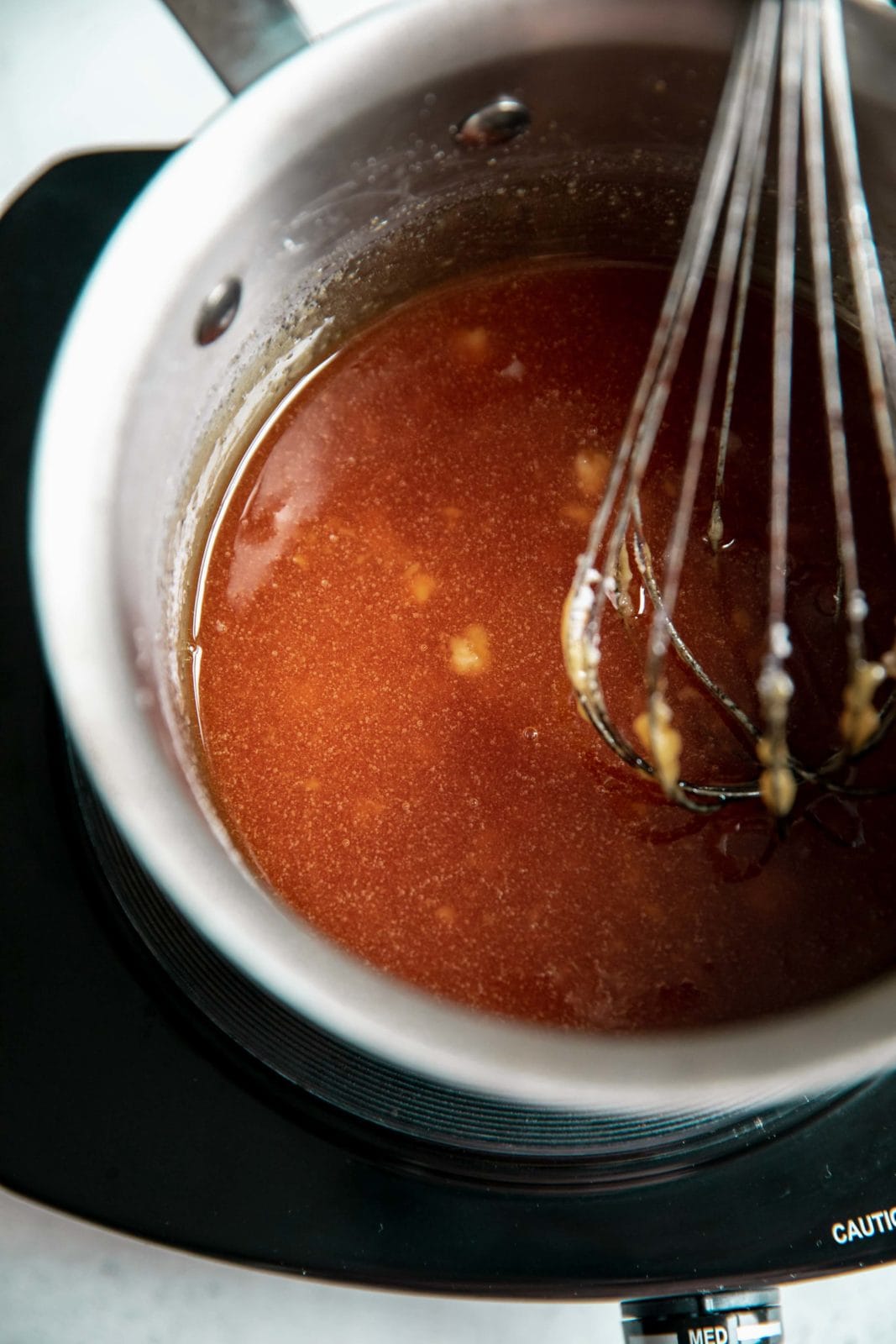 Sugar is melted with a few clumps remaining