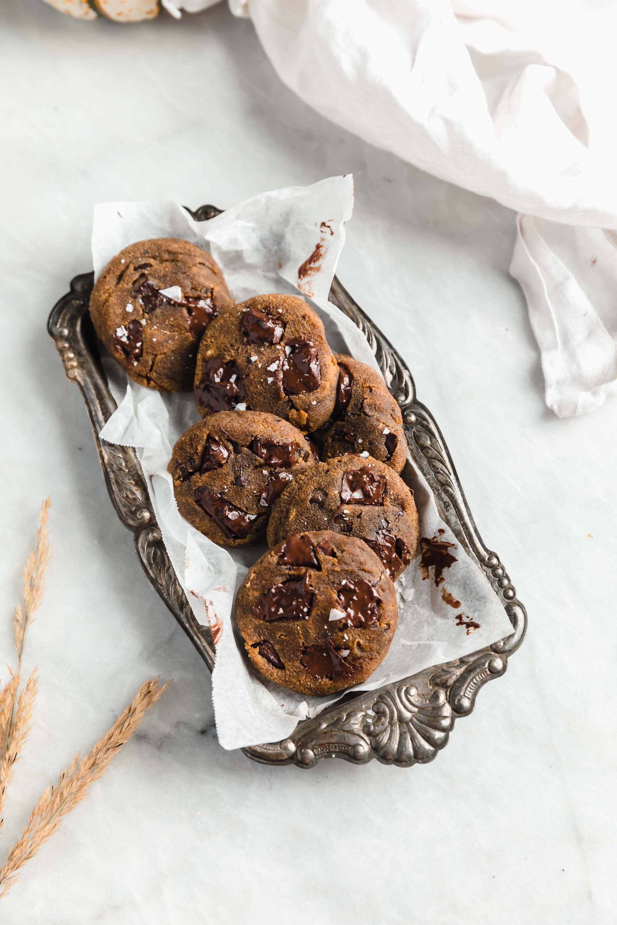 pumpkin chocolate chip cookies on a decorative tin