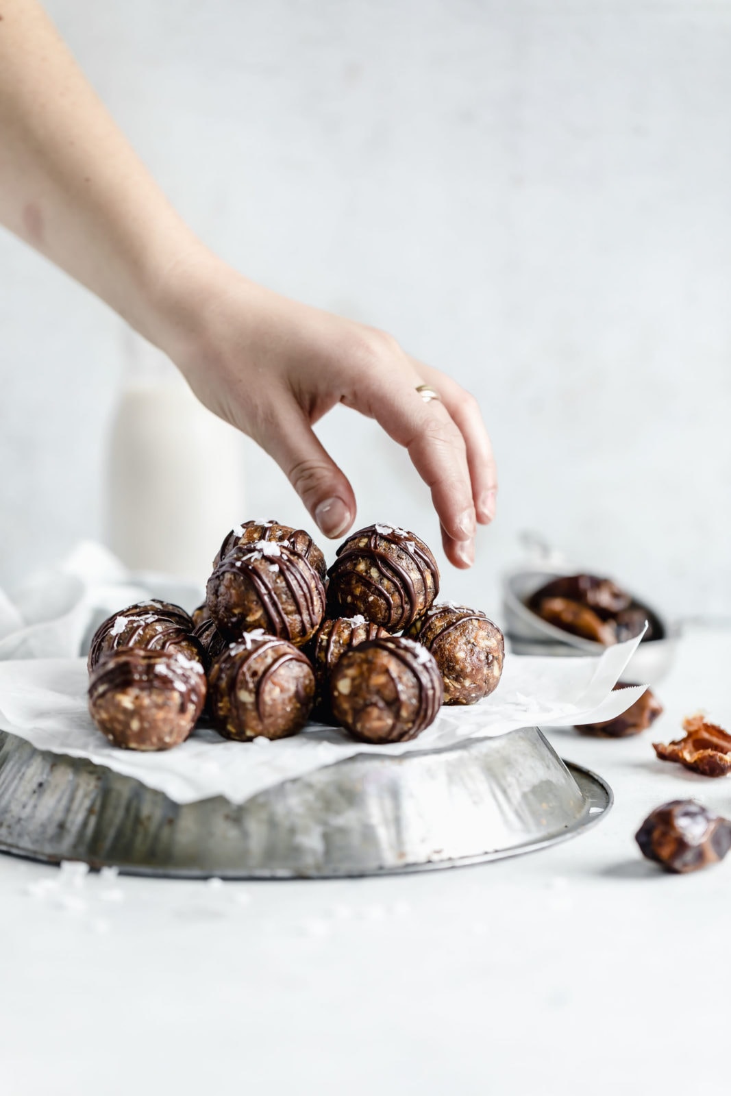 grabbing for a peanut butter oat energy ball