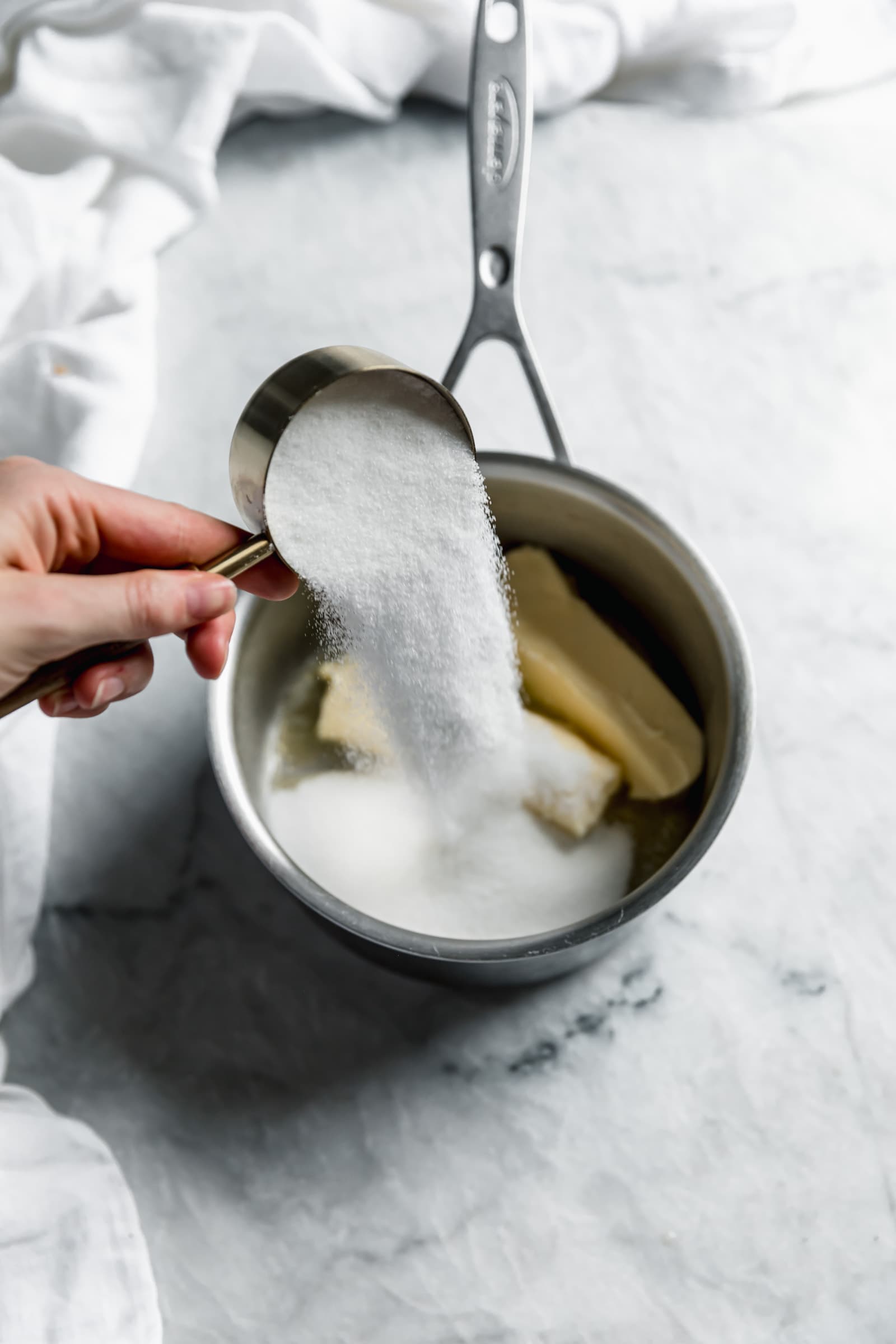 sugar pouring into pot