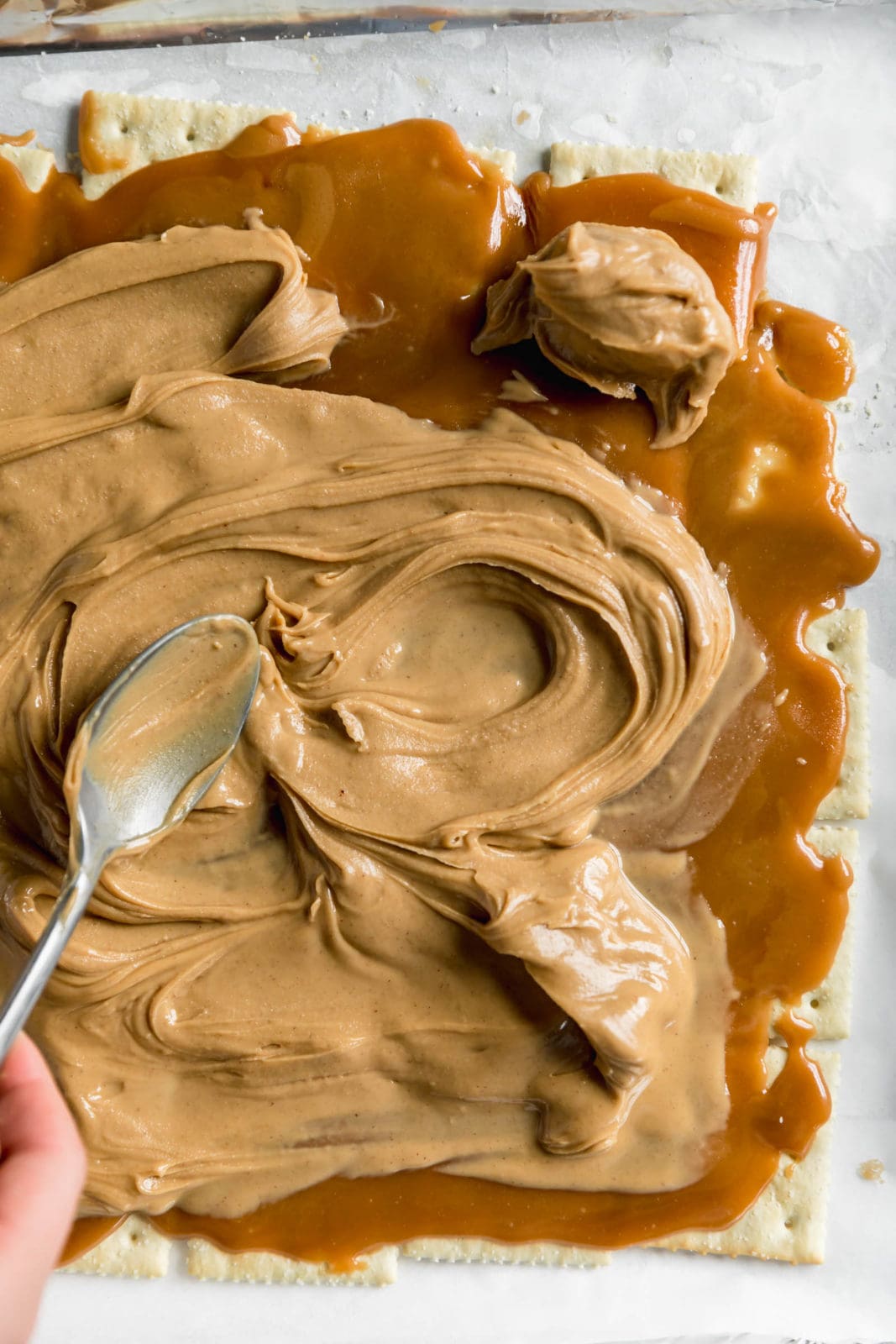 peanut butter spread over saltine toffee