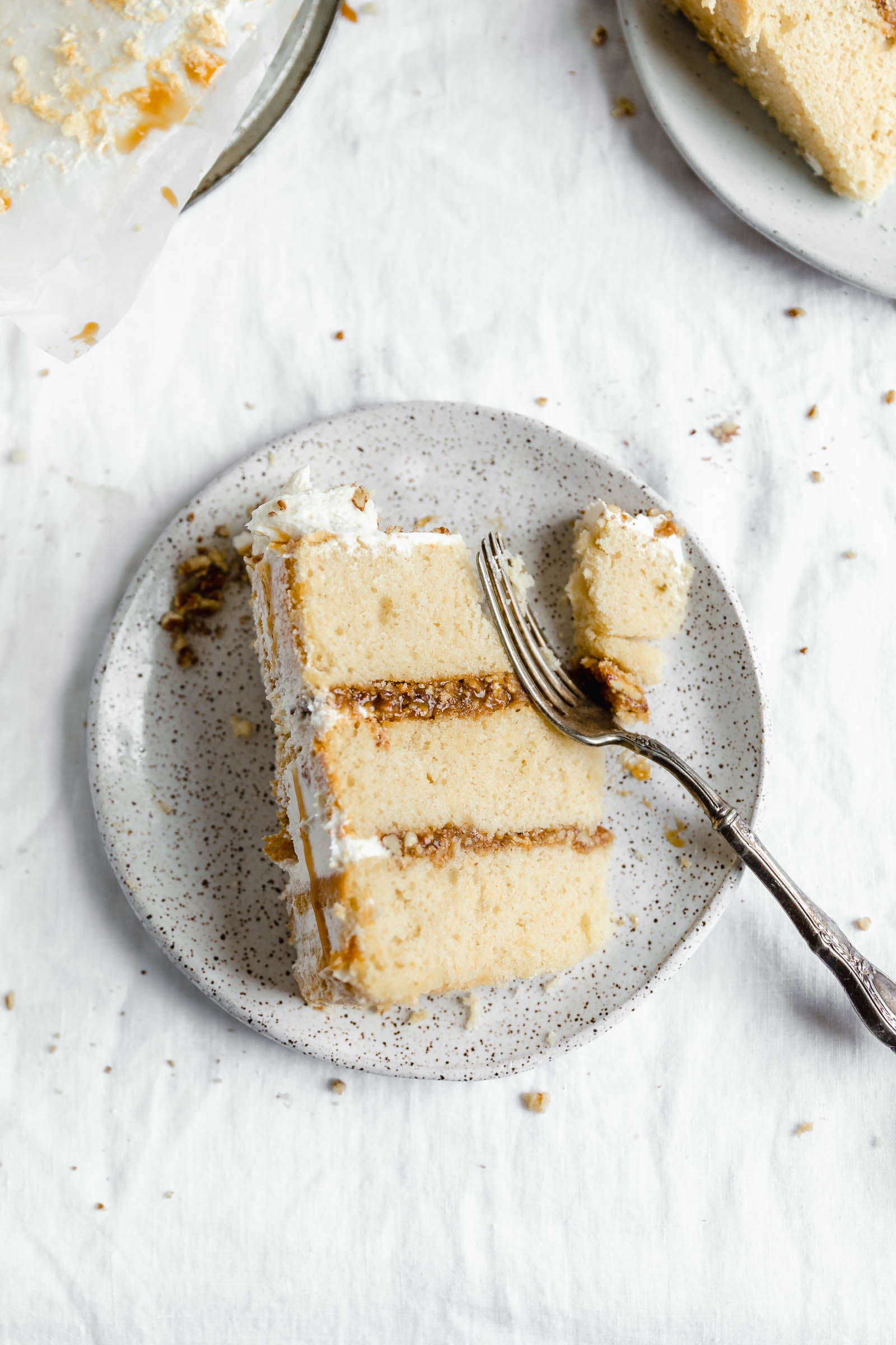 slice of praline layer cake with a bite taken out