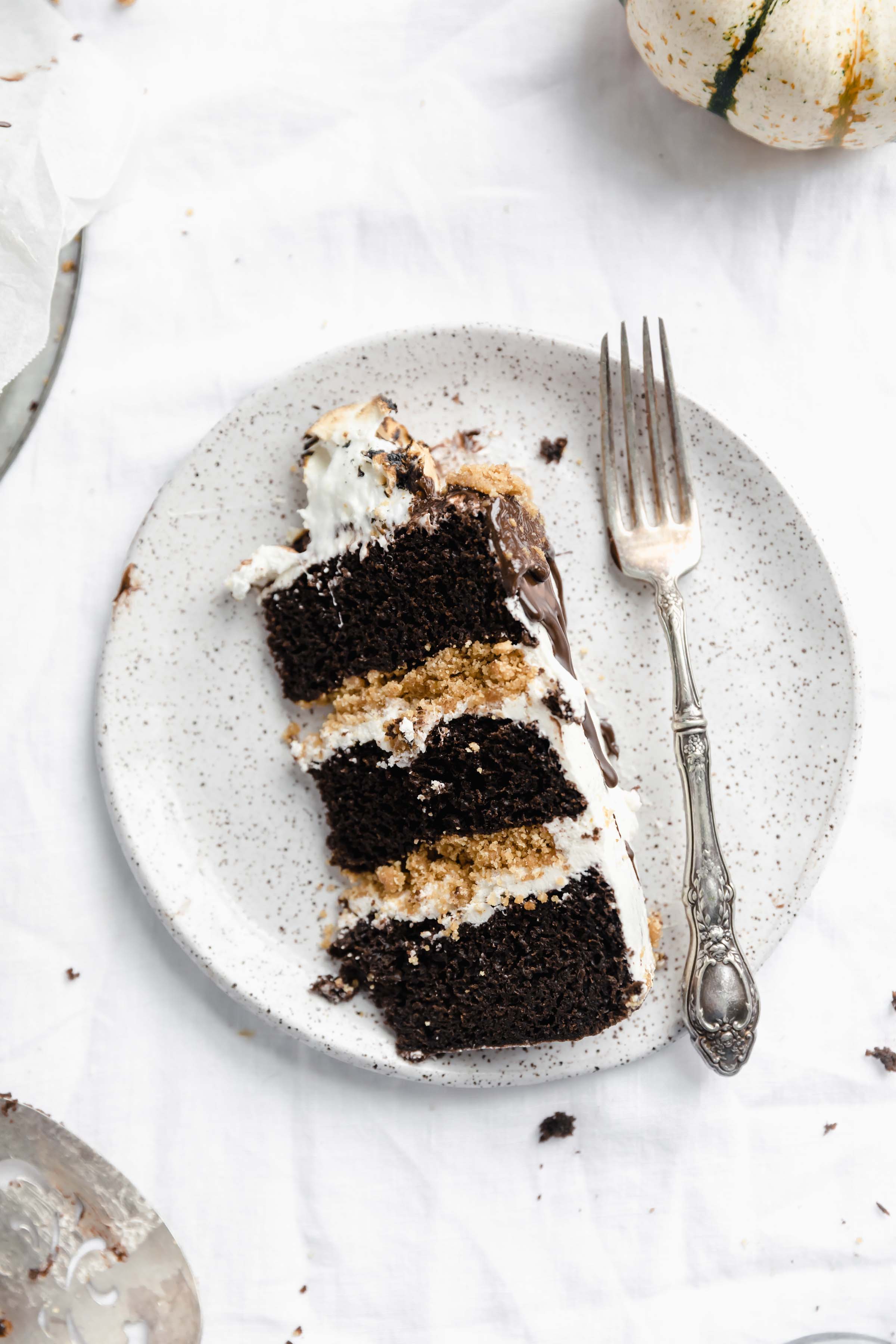 slice of s'mores cake with fork on a plate