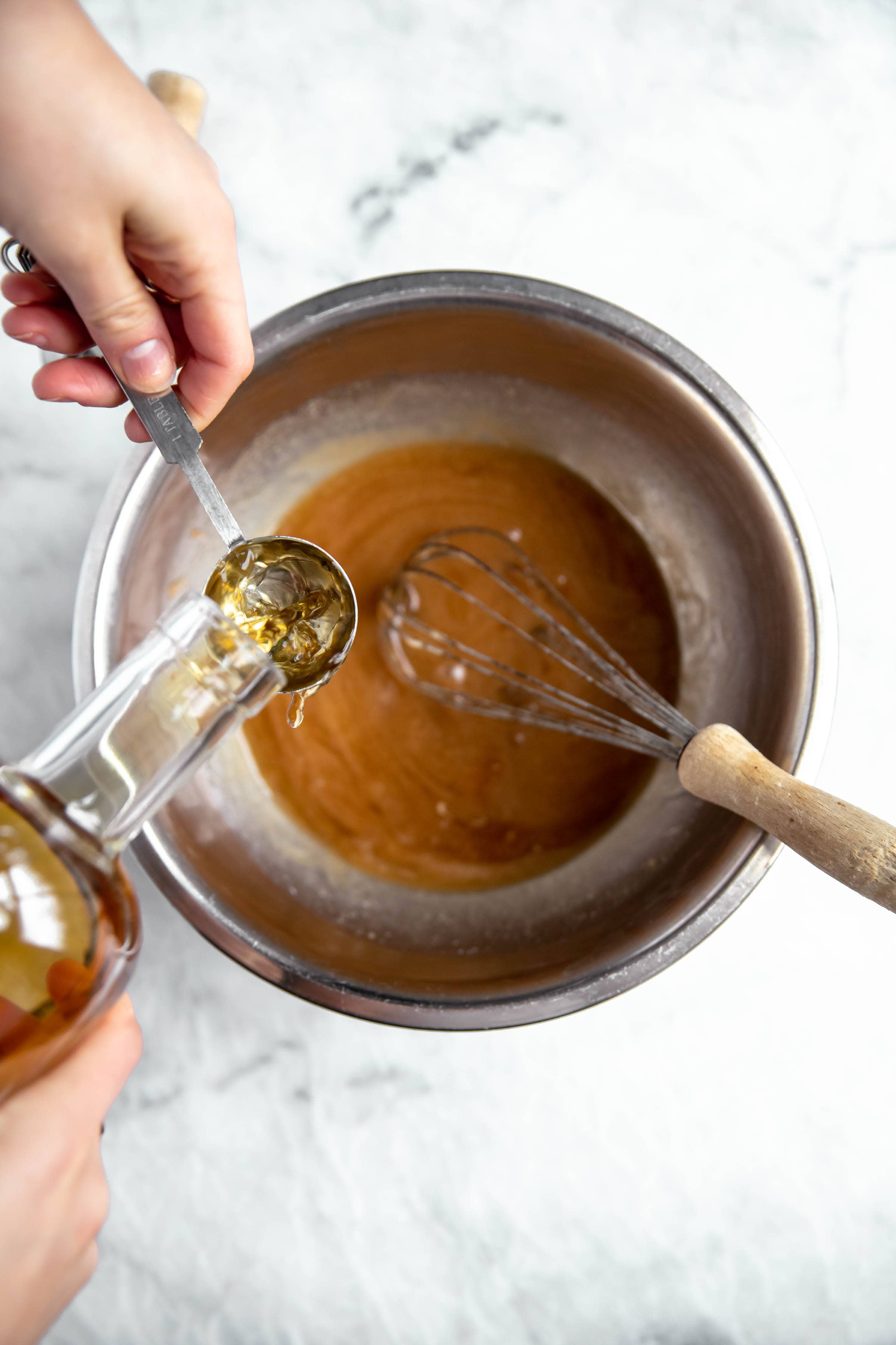 bourbon poured into bourbon pecan pie batter
