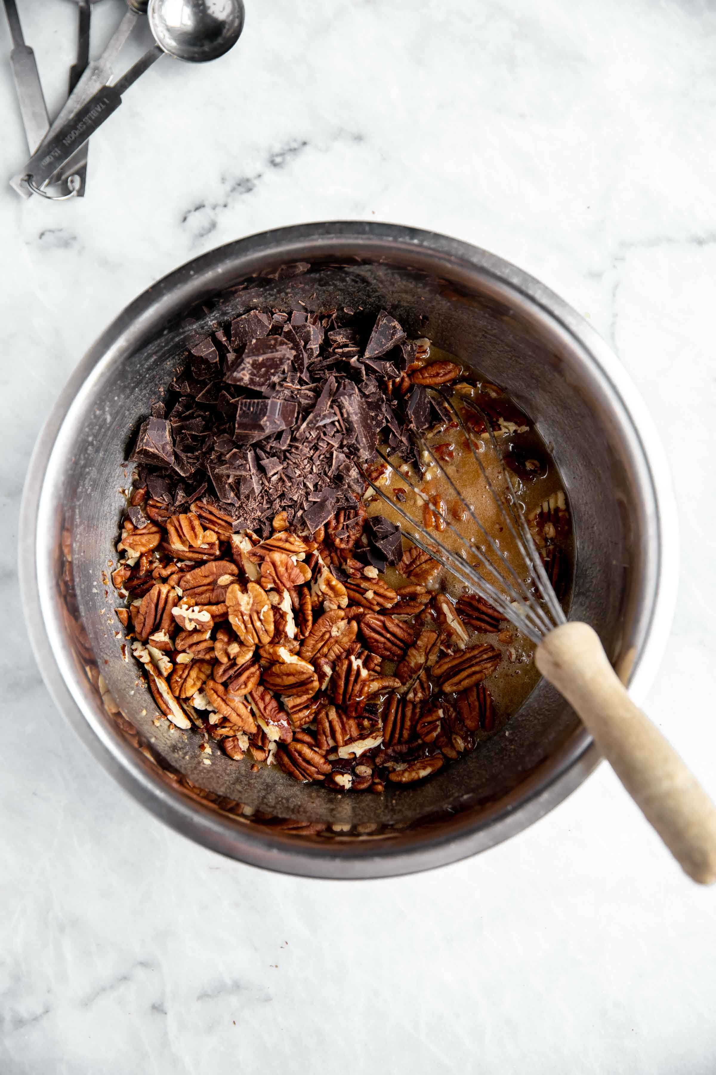 overhead process shot of bourbon chocolate pecan pie