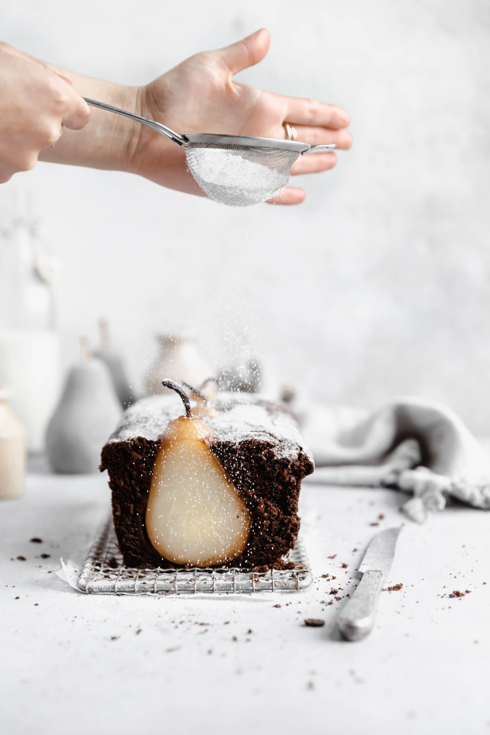 powdered sugar sprinkled over gingebread pear loaf cake