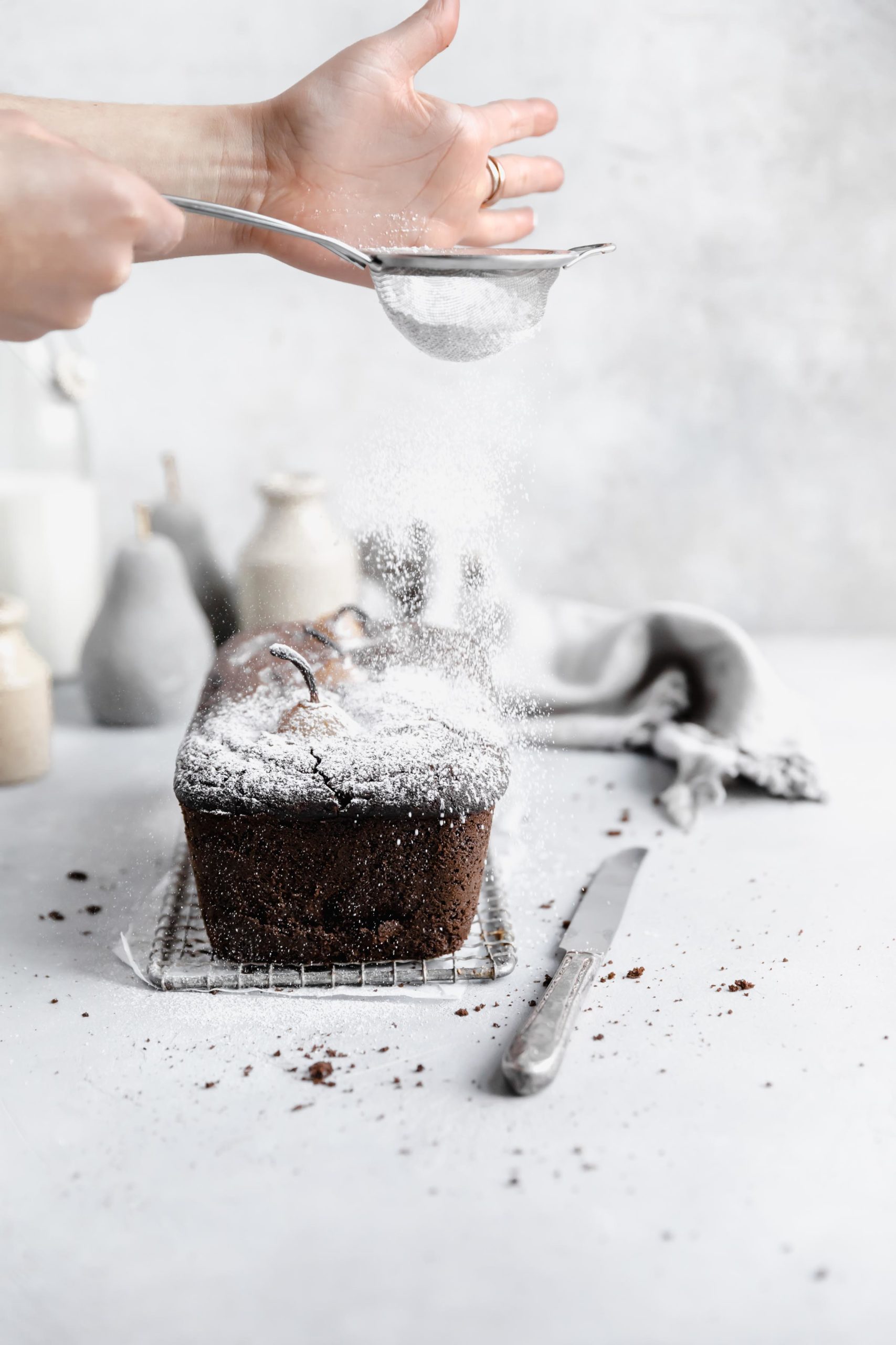 poached pear gingerbread cake with a dusting of powdered sugar