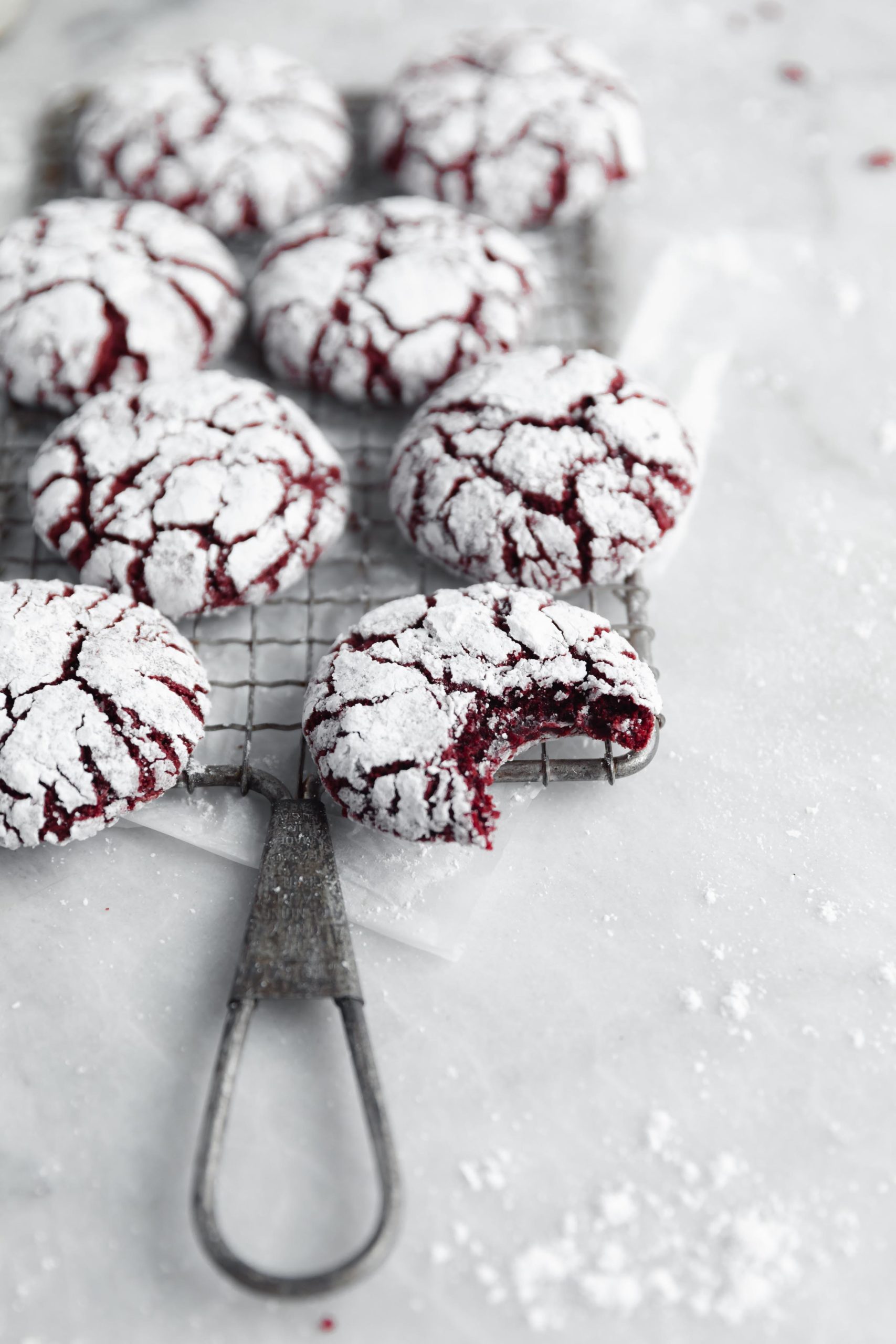 homemade red velvet crinkle cookies on a metal grate