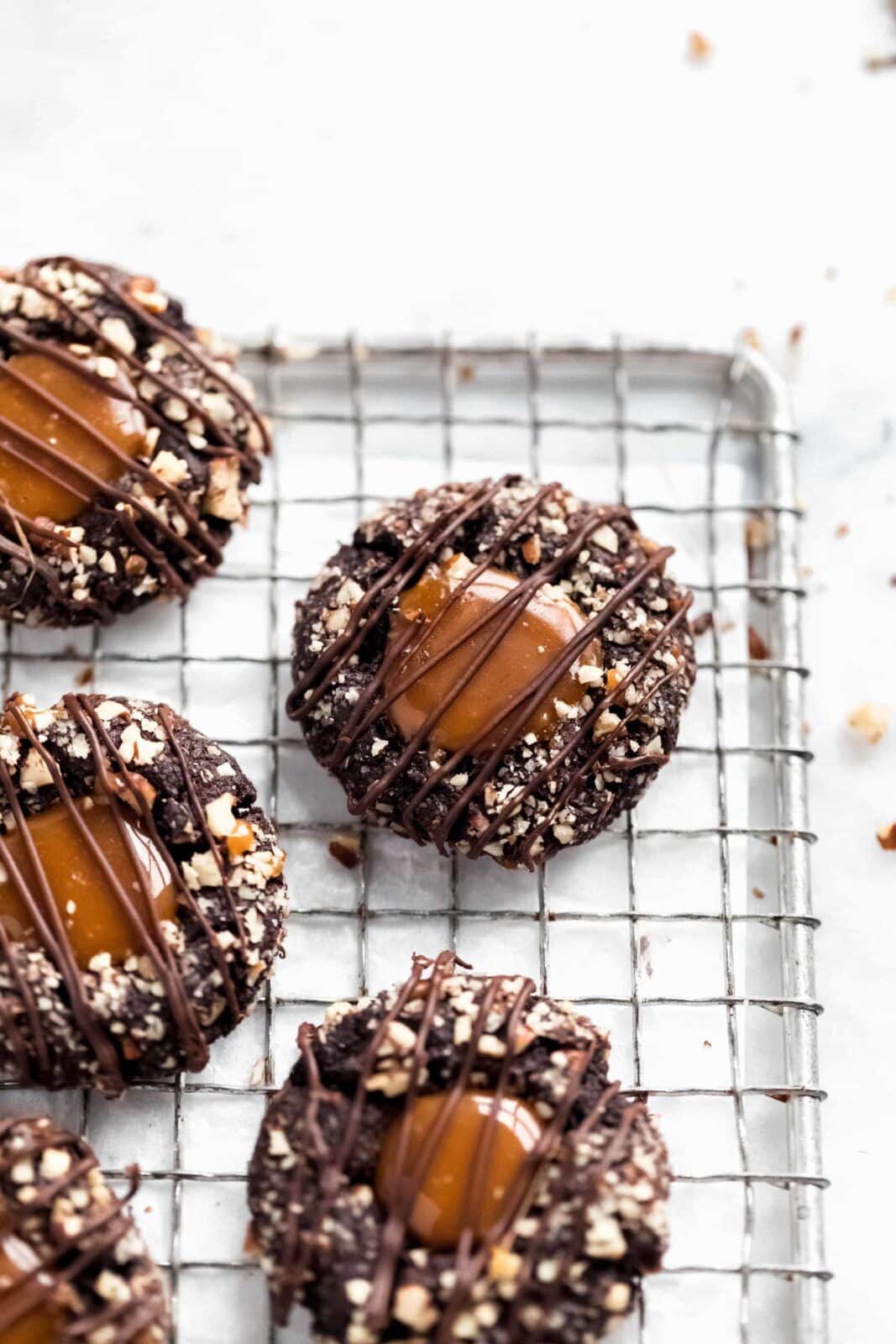 These turtle thumbprint cookies complete with a gooey caramel center and pecan coating. Try not to eat five?