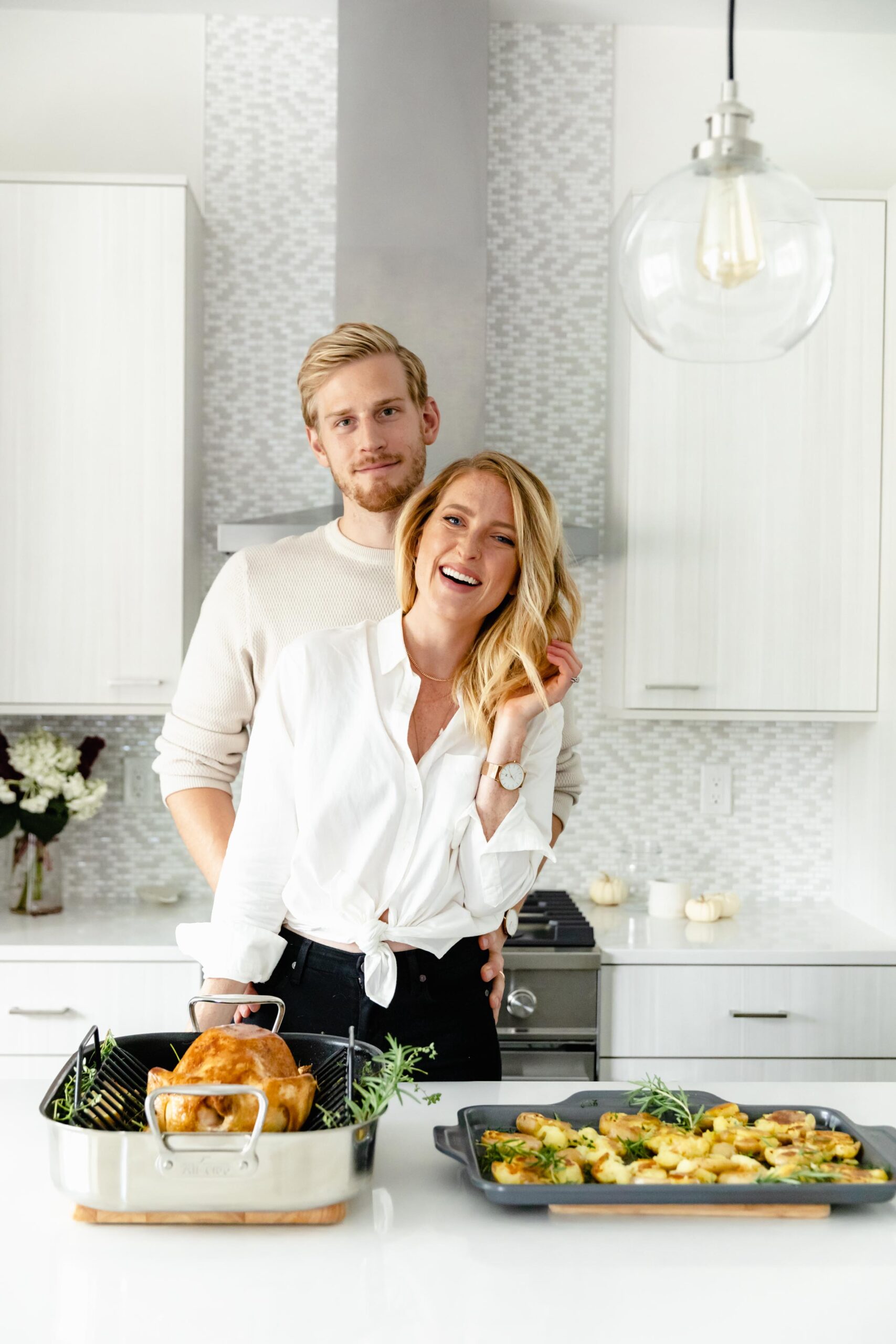 newlywed couple entertaining in kitchen