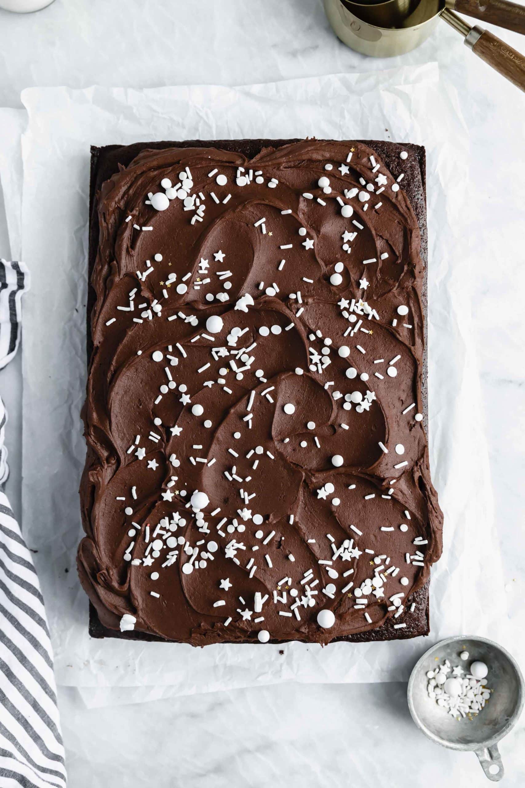overhead shot of easy gluten free chocolate cake with chocolate buttercream and spinrkles
