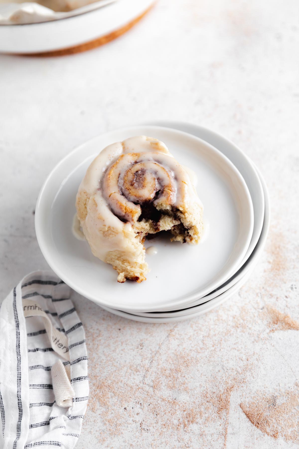 gluten free vegan cinnamon roll with a bite taken out