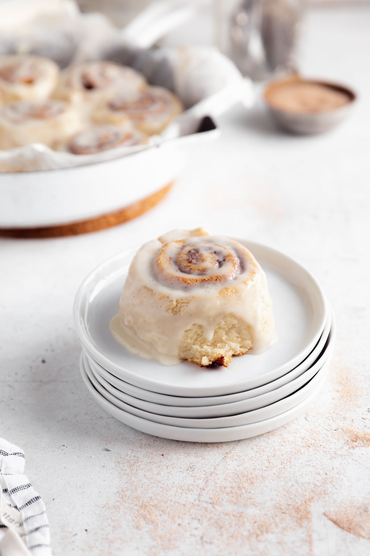 gluten fere vegan cinnamon roll on a stack of plates