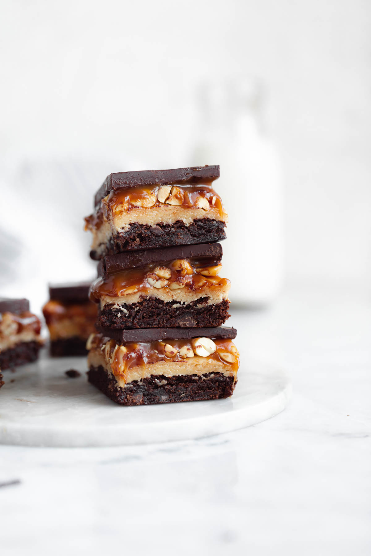 stack of snickers brownies with gooey caramel