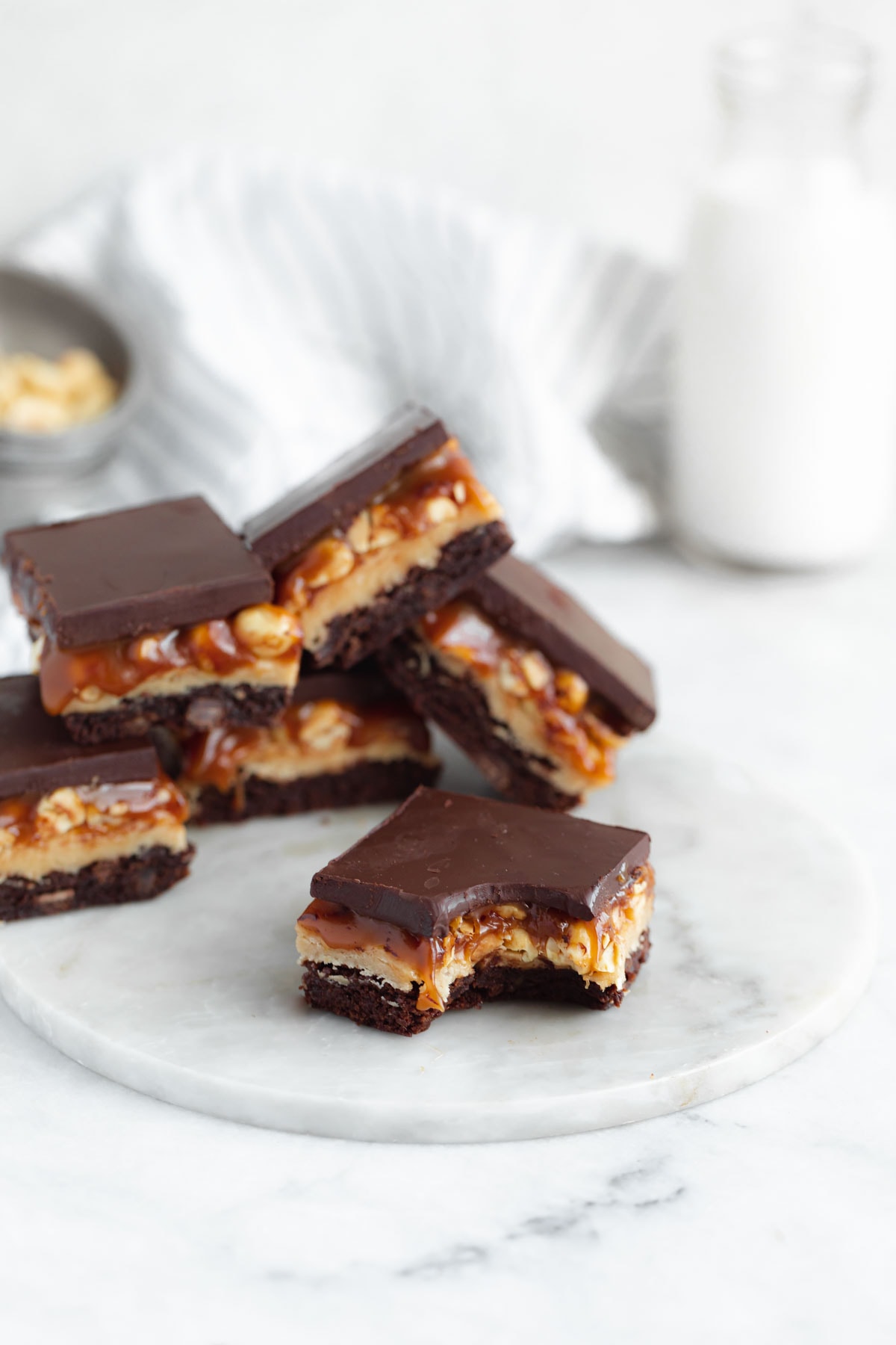 snickers brownies in a pile with a bite taken out