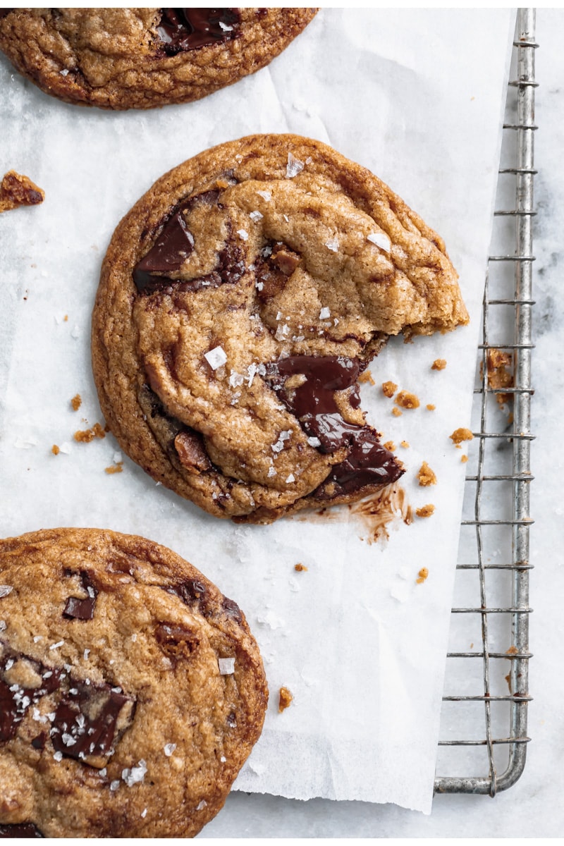 brown butter toffee chocolate chip cookie with a bite taken out of it