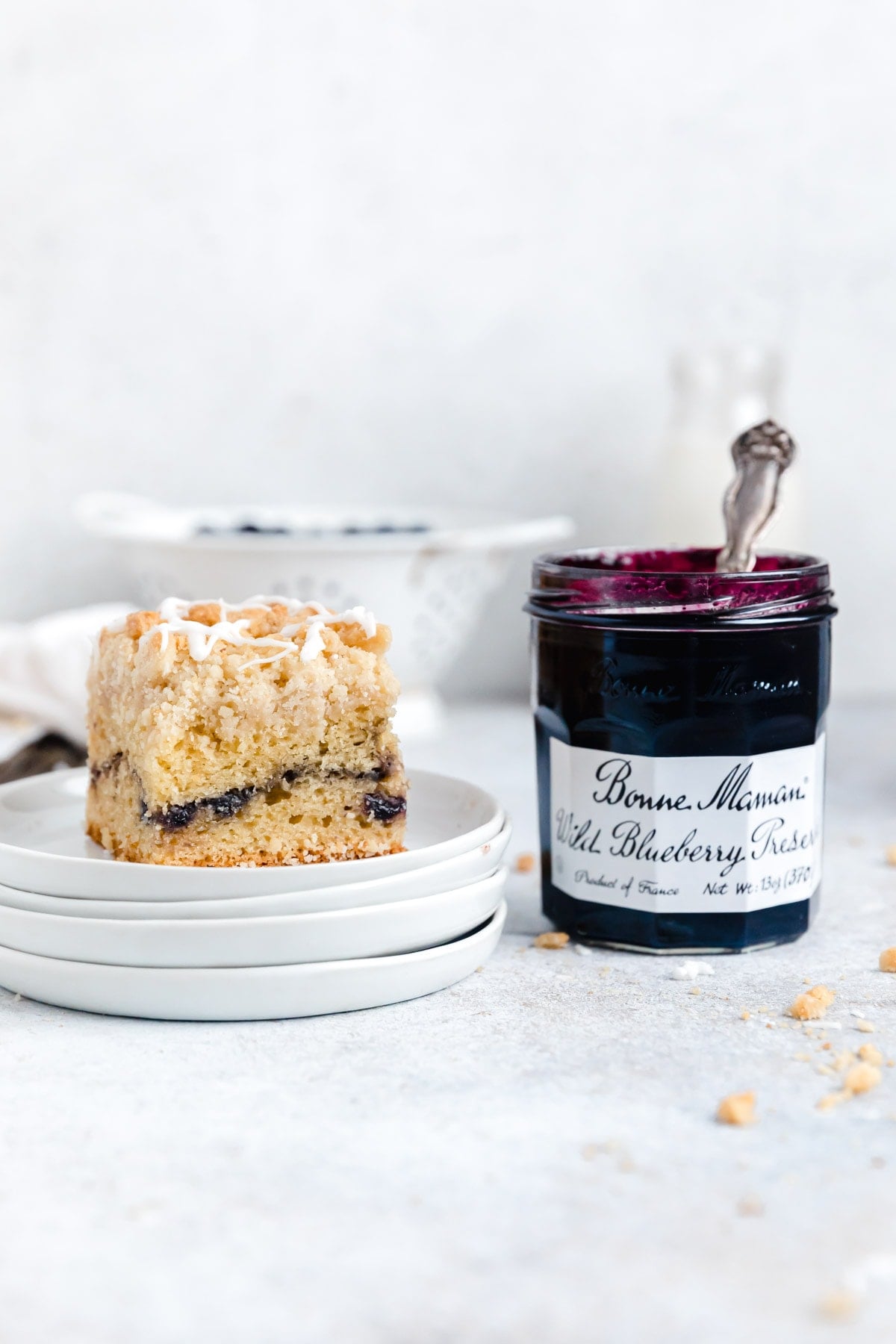 blueberry crumb cake on a stack of plates
