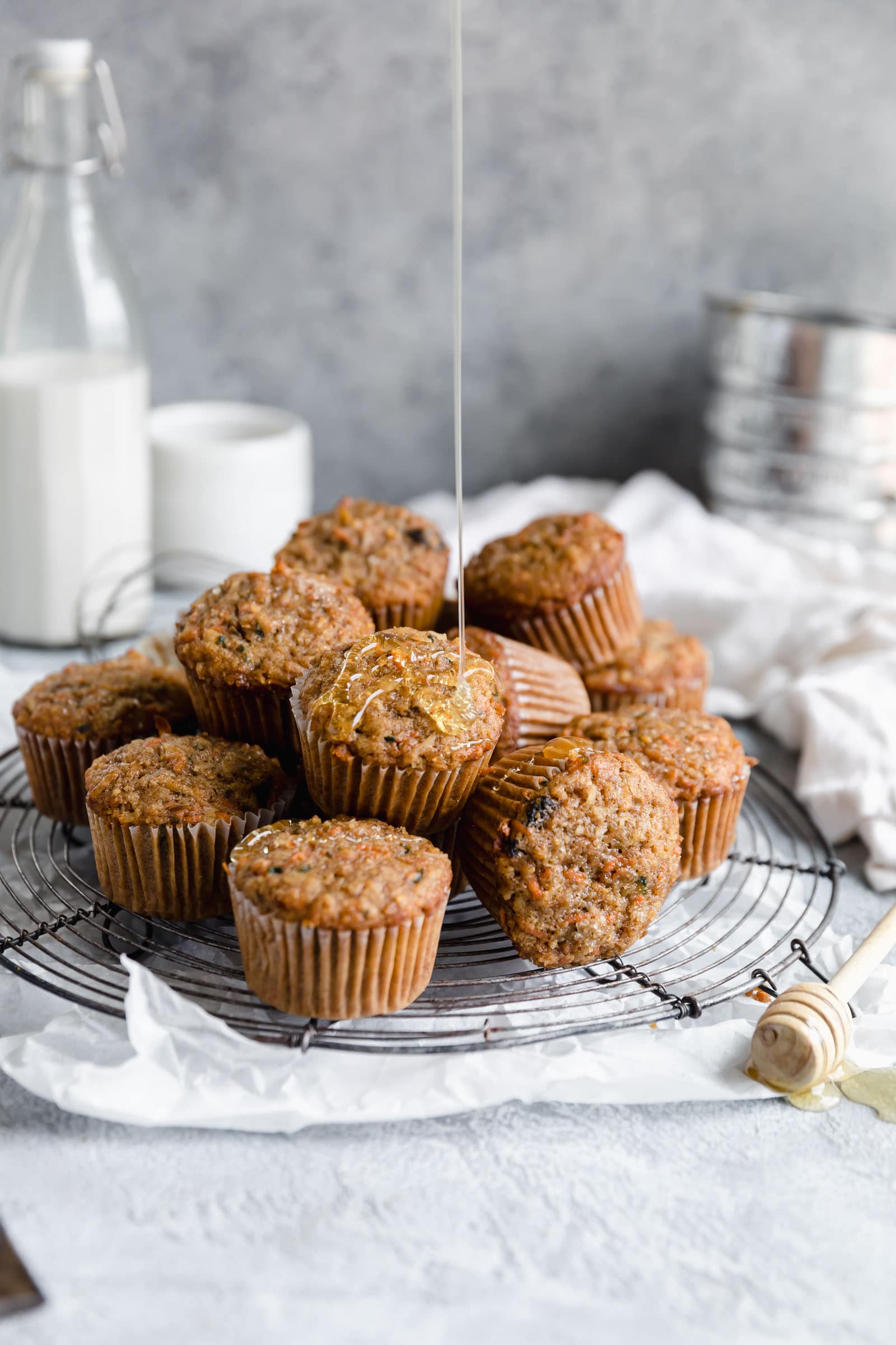 pile of morning glory muffins drizzled with honey