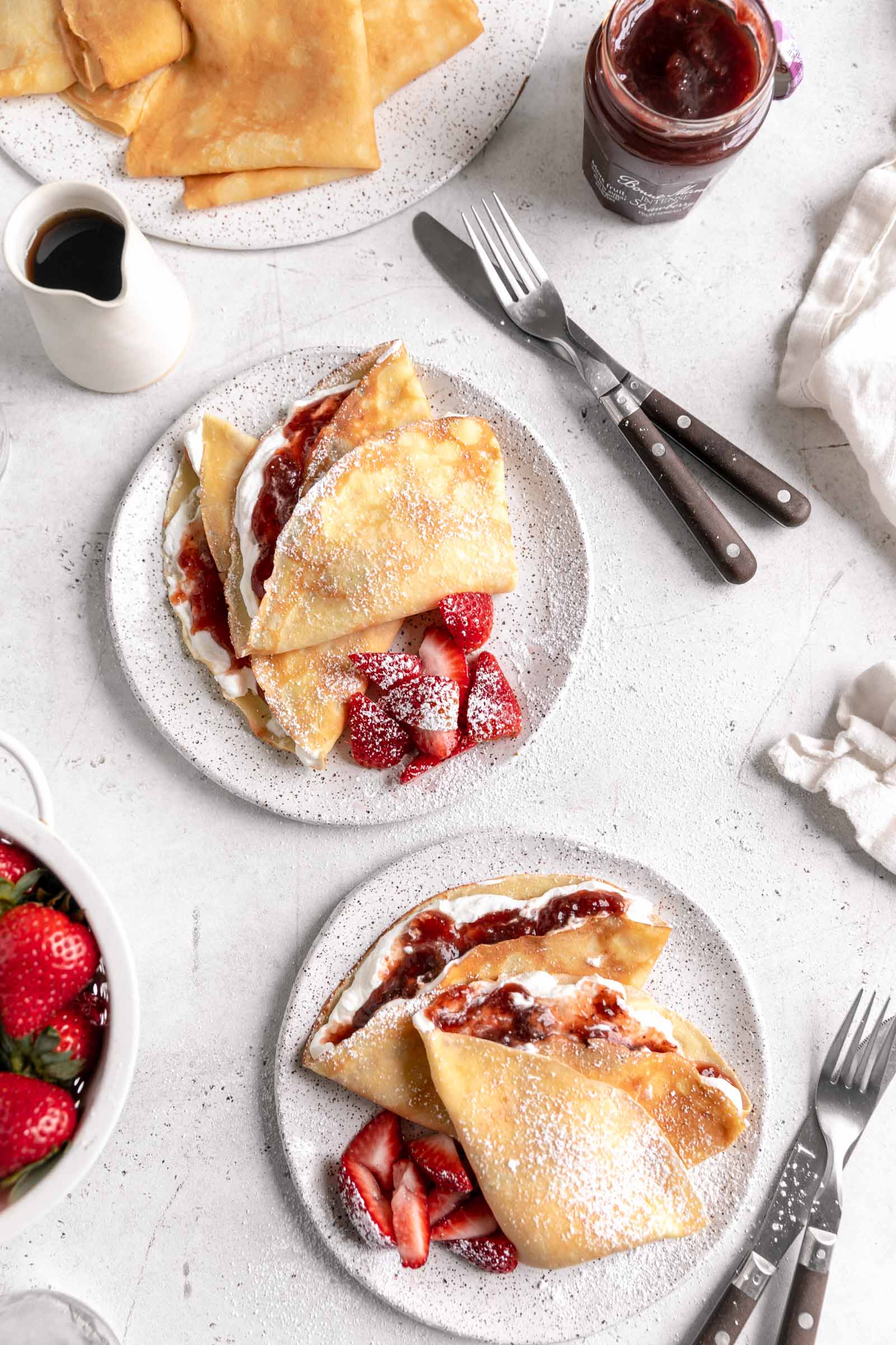 homemade crepes with strawberry jam and whipped cream