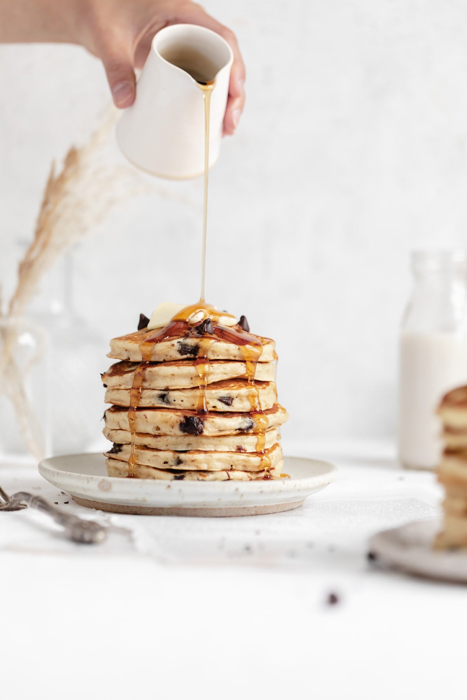 fluffy chocolate chip pancakes with maple syrup and butter