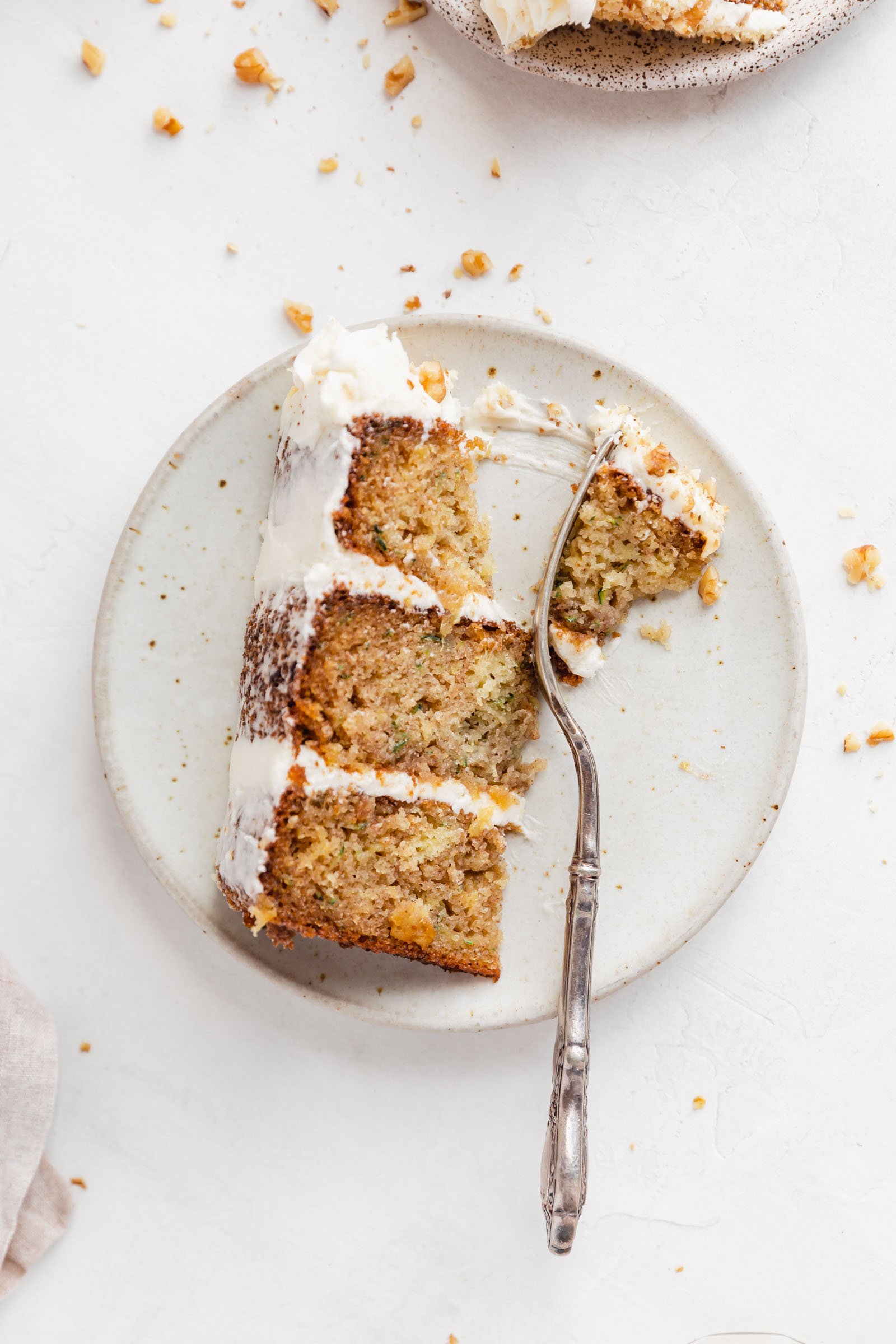 zucchini layer cake with cream cheese icing on a plate