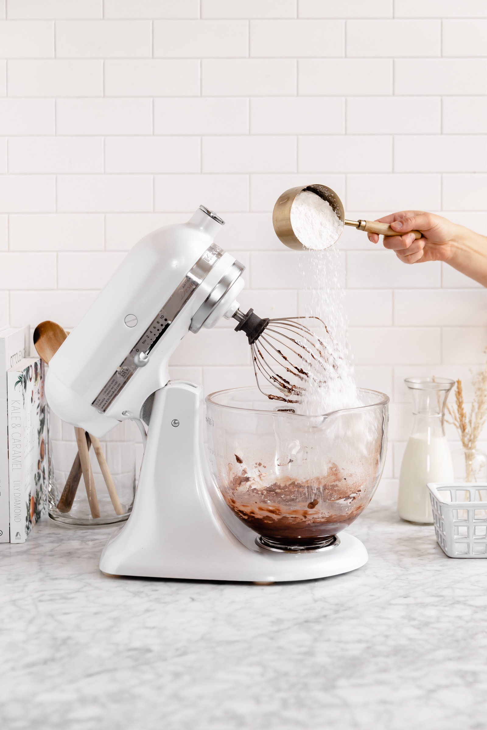 confectioners sugar going into a stand mixer