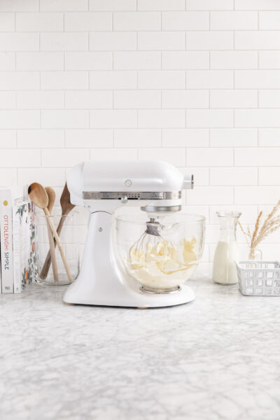 step by step cream cheese frosting beating in a bowl