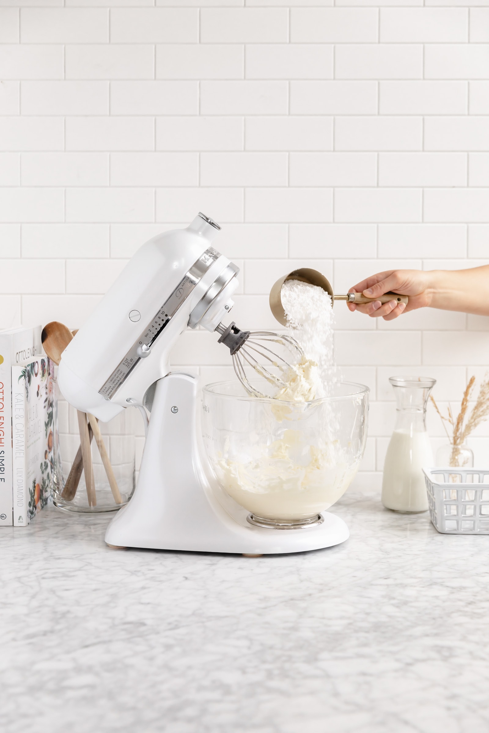 powdered sugar pouring into frosting