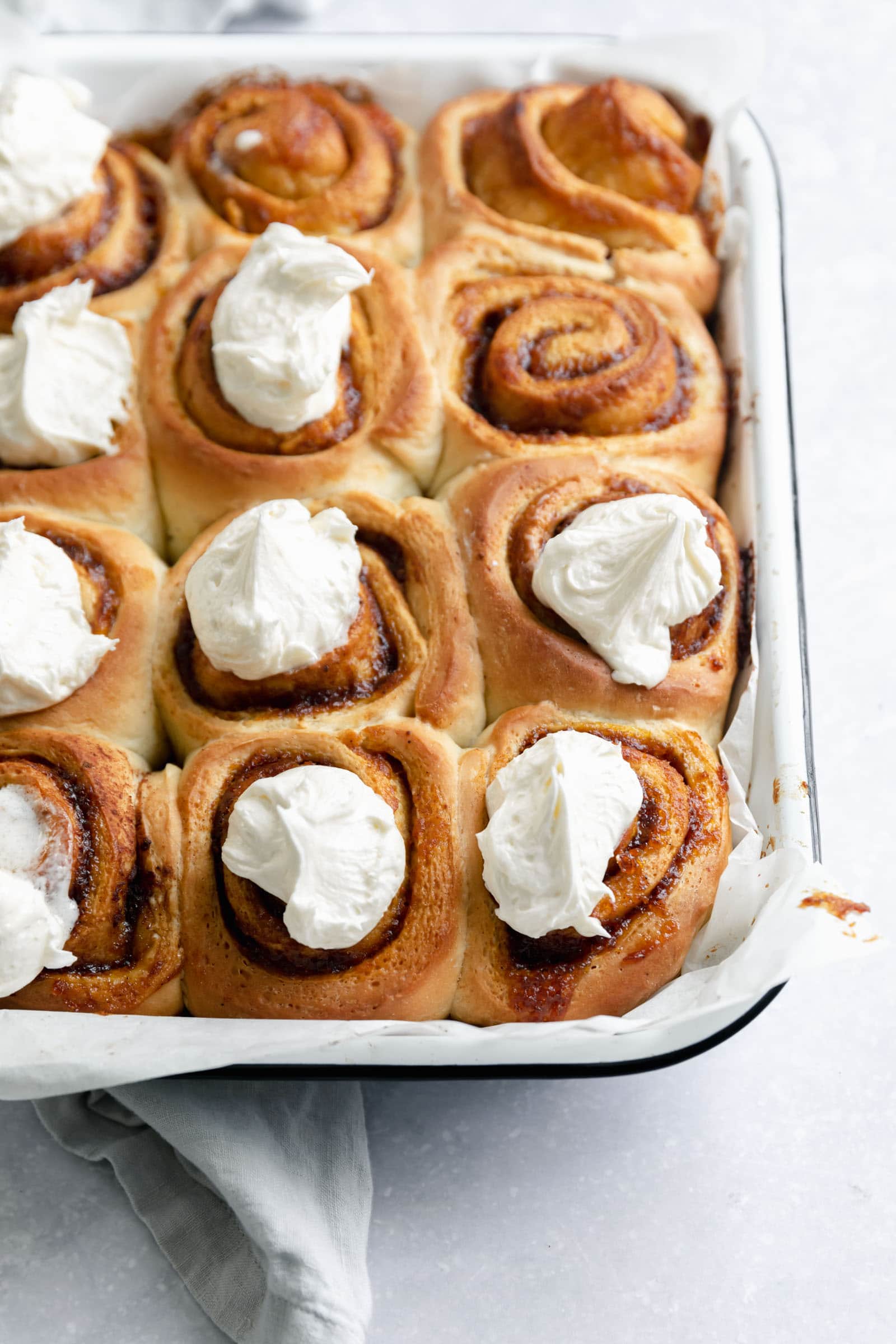 pumpkin cinnamon rolls with dollops of frosting