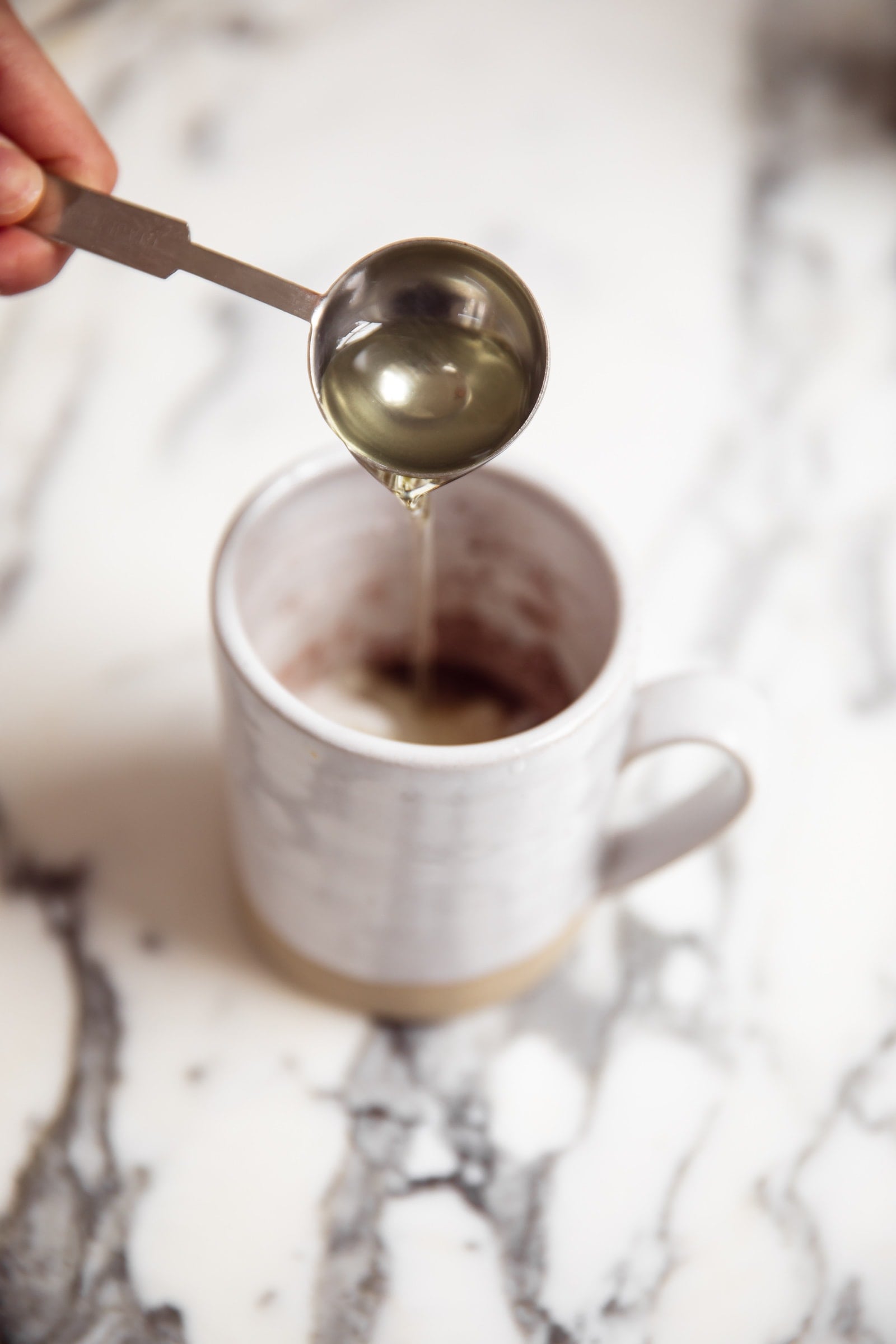 wet ingredients going into mug